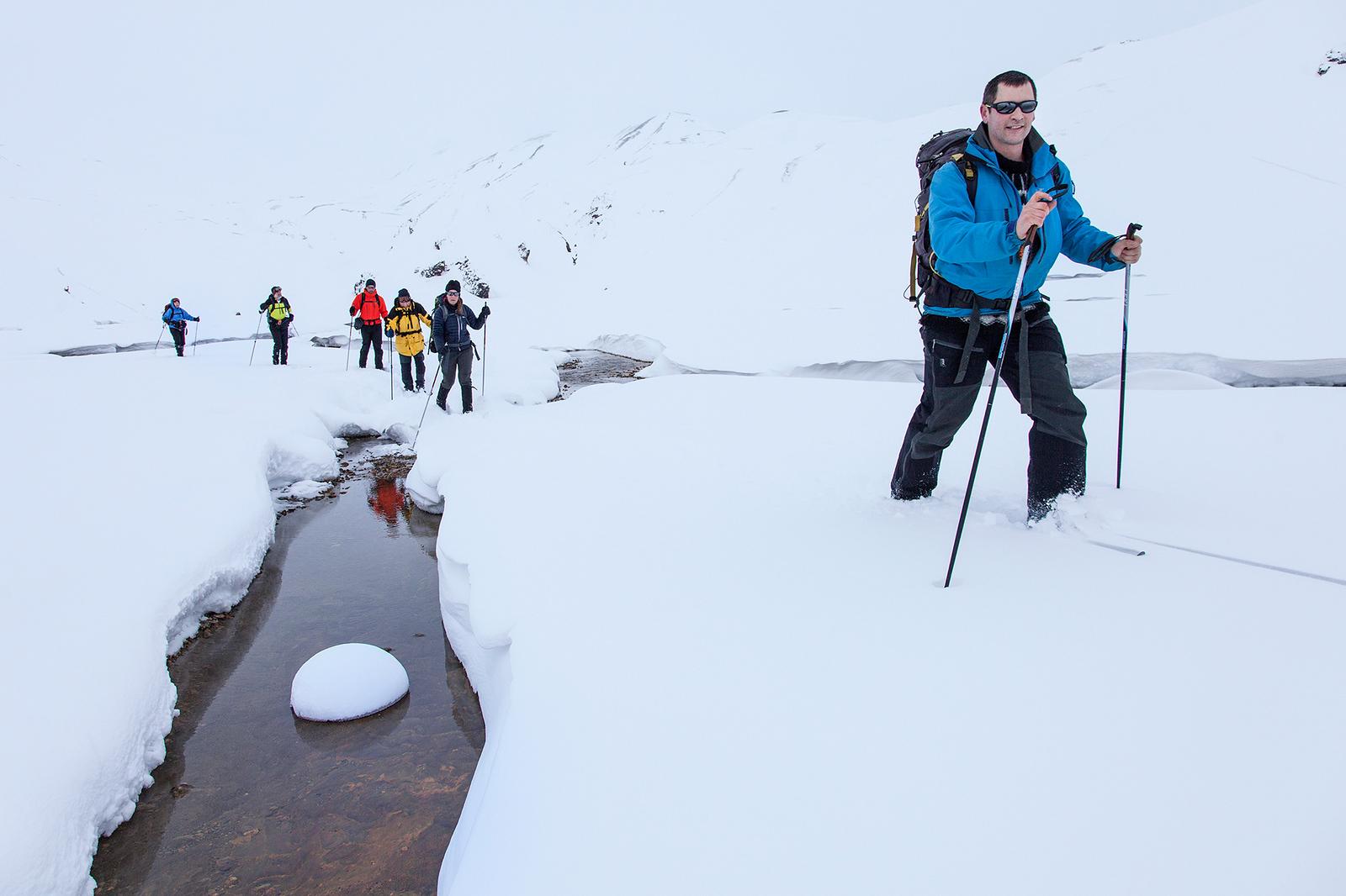 People hiking in snow at Landmannalaugar
