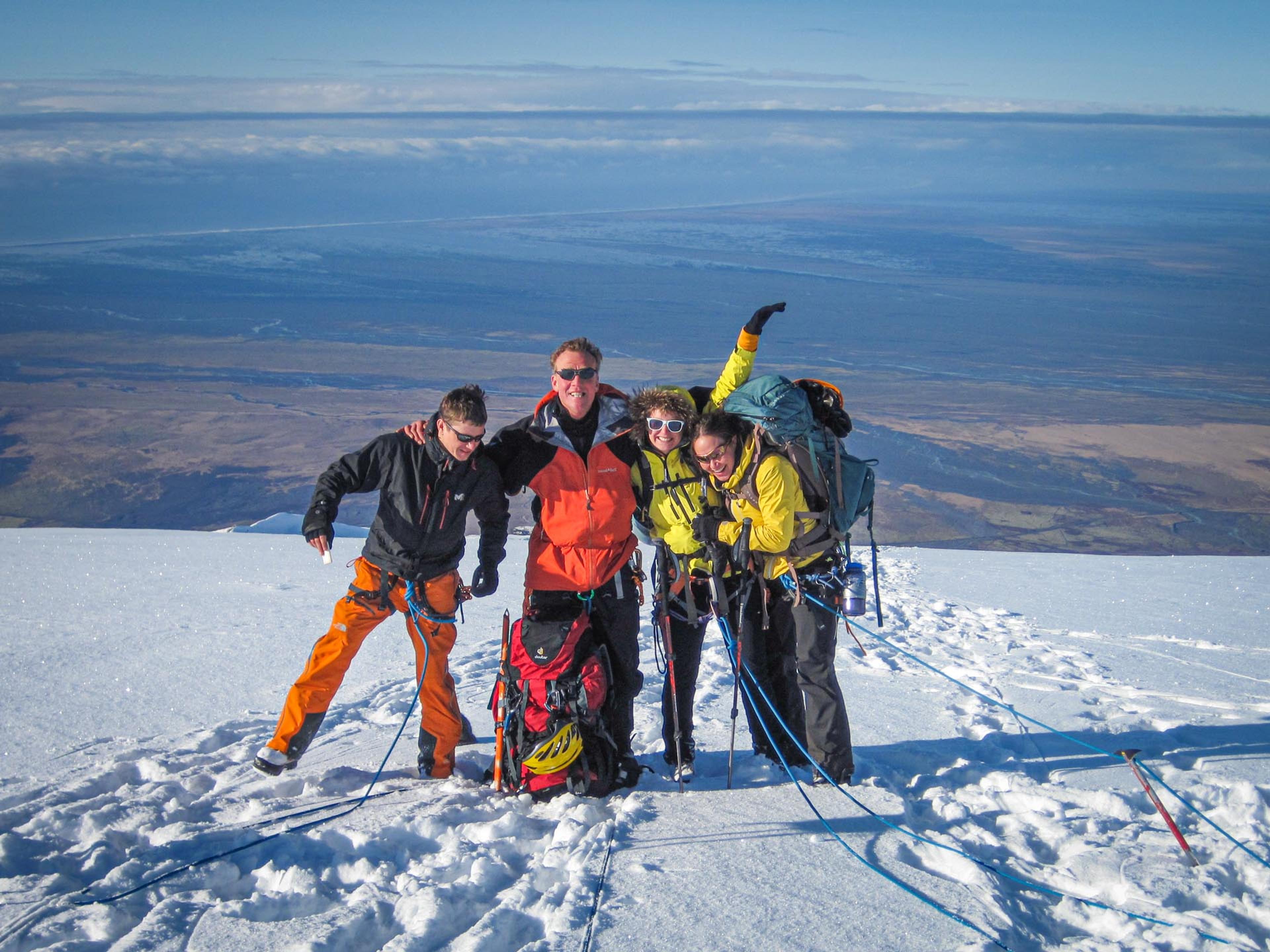 four people posing after hiking in the snow