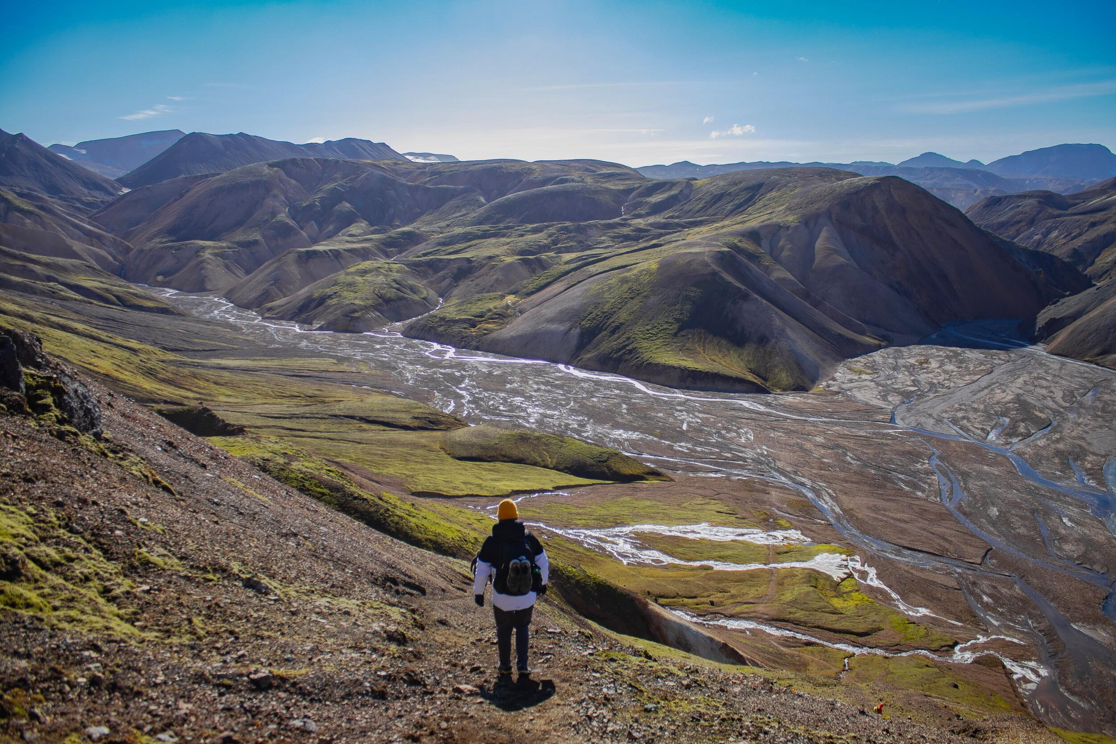person hiking in a green mountains