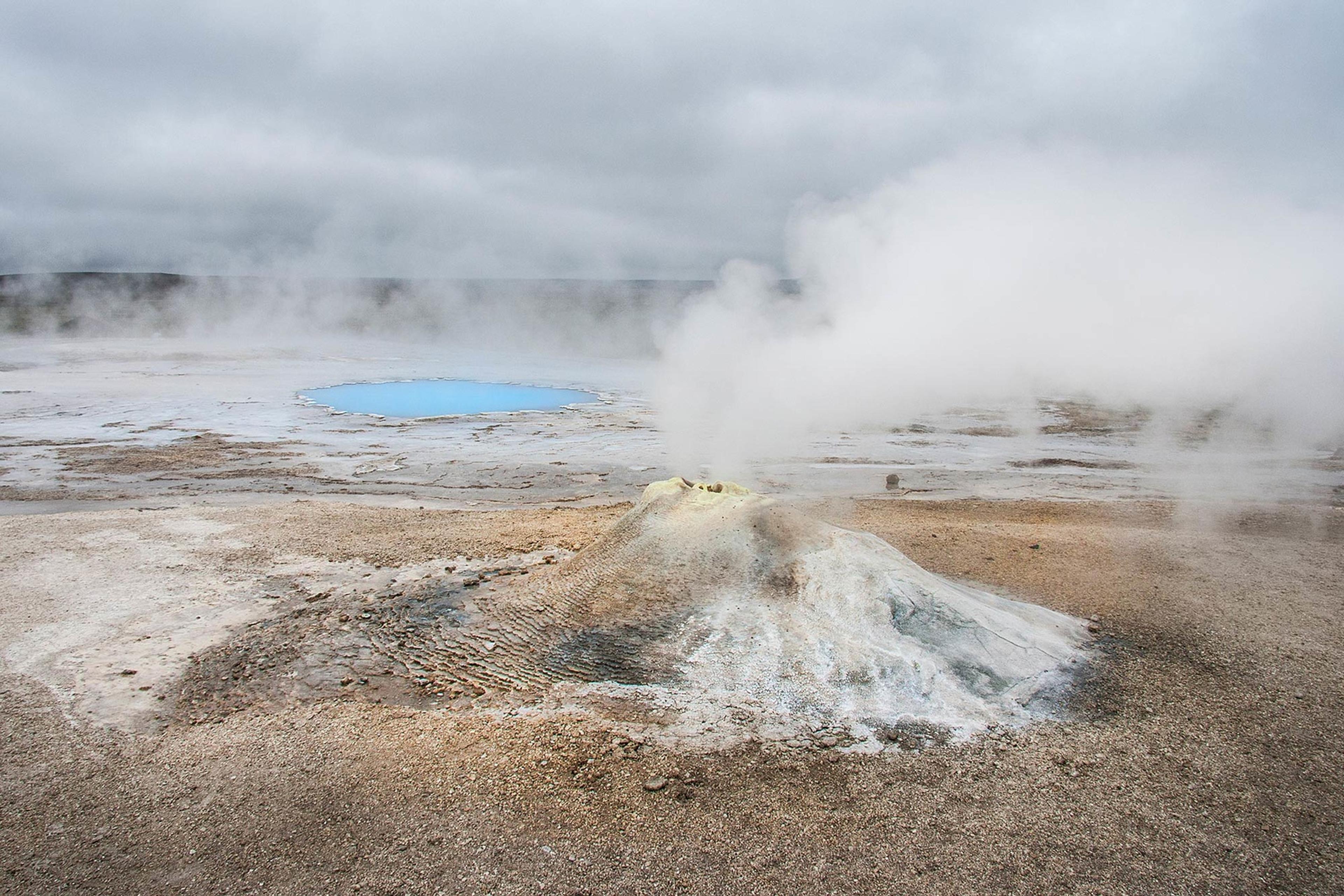 A steam went and an bright blue hot water pool in the back ground