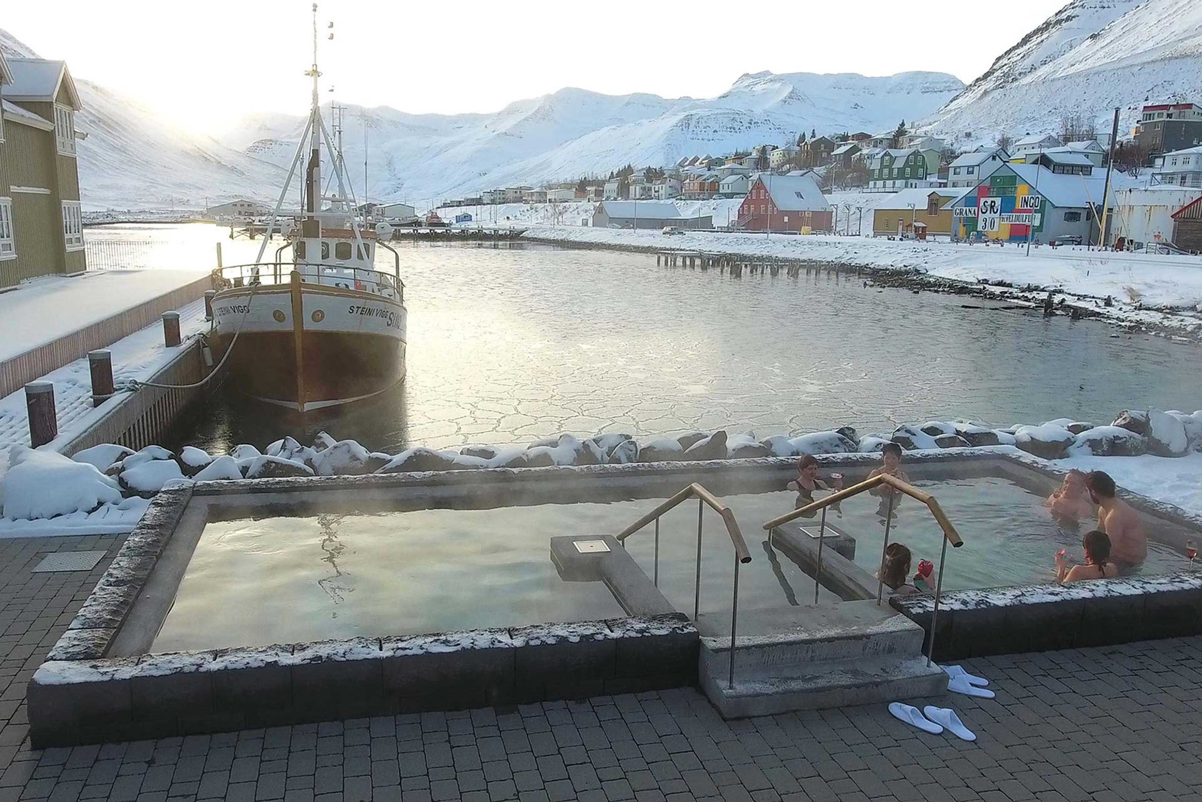 The Siglo Hotel hot tub just by the harboar and a boat docked close by