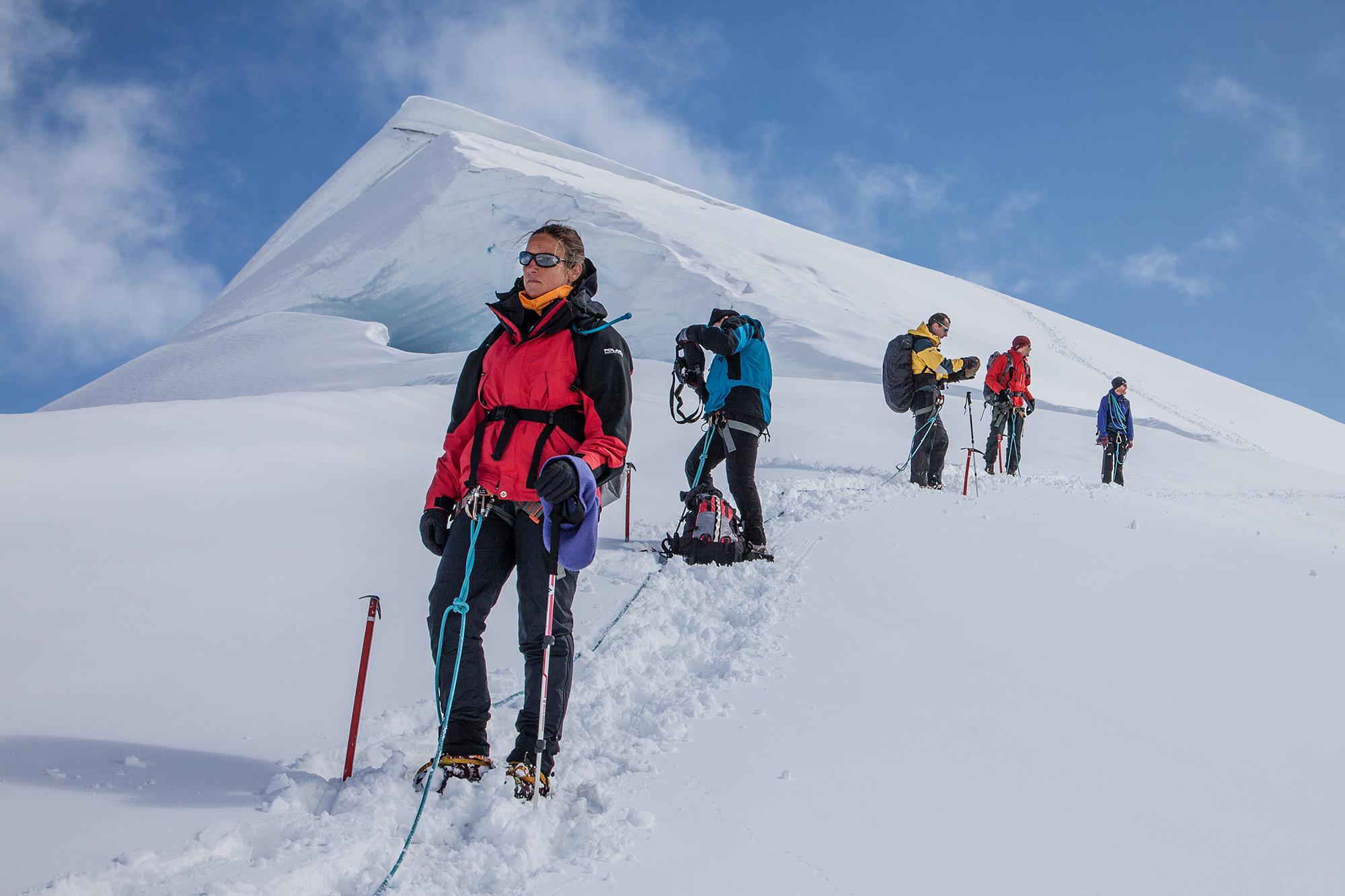 people hiking up Hrútsfjallstindar on a sunny day