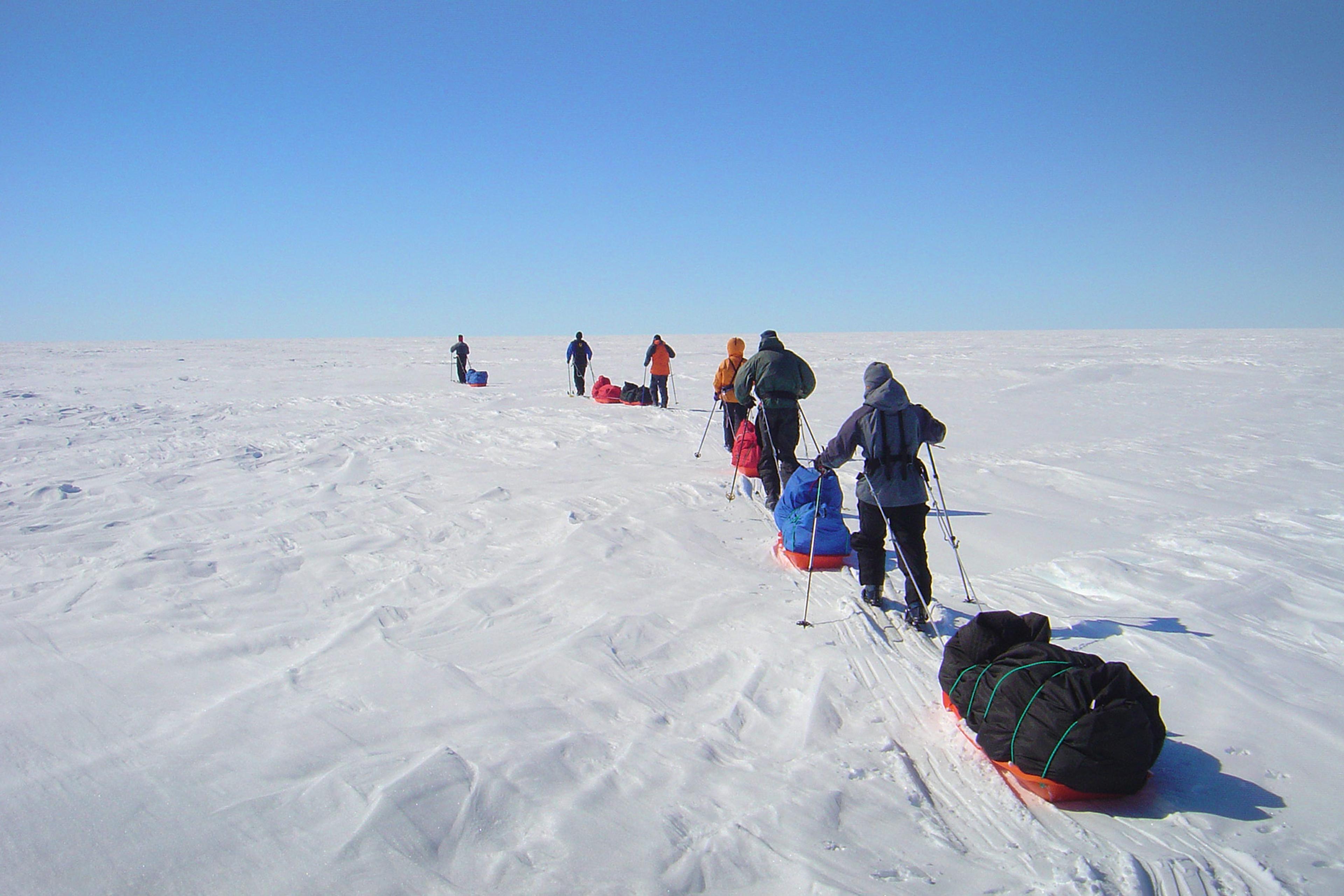 A group of people skiing on the Greenland ice sheet
