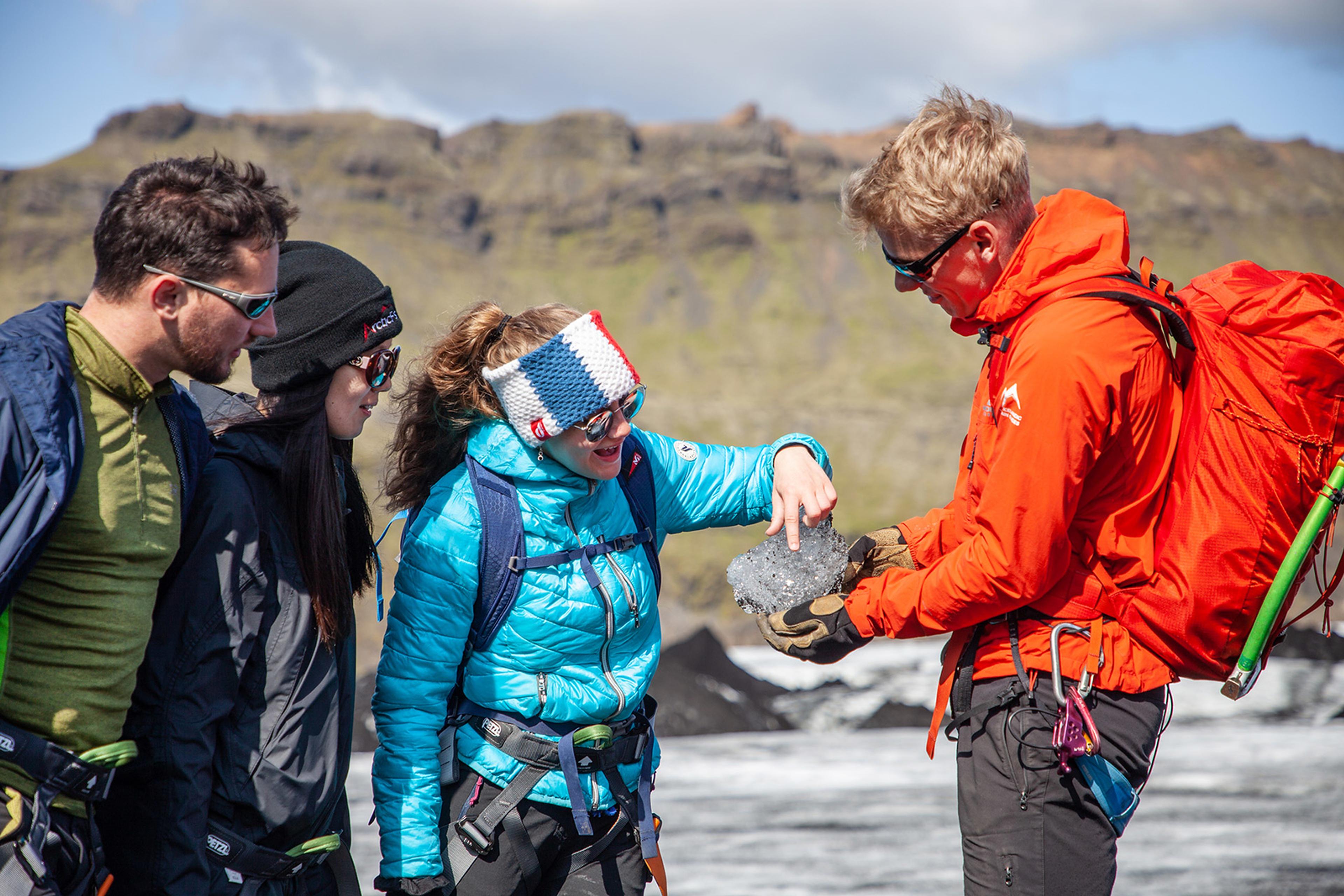 The guide letting the guests touch a piece of ice