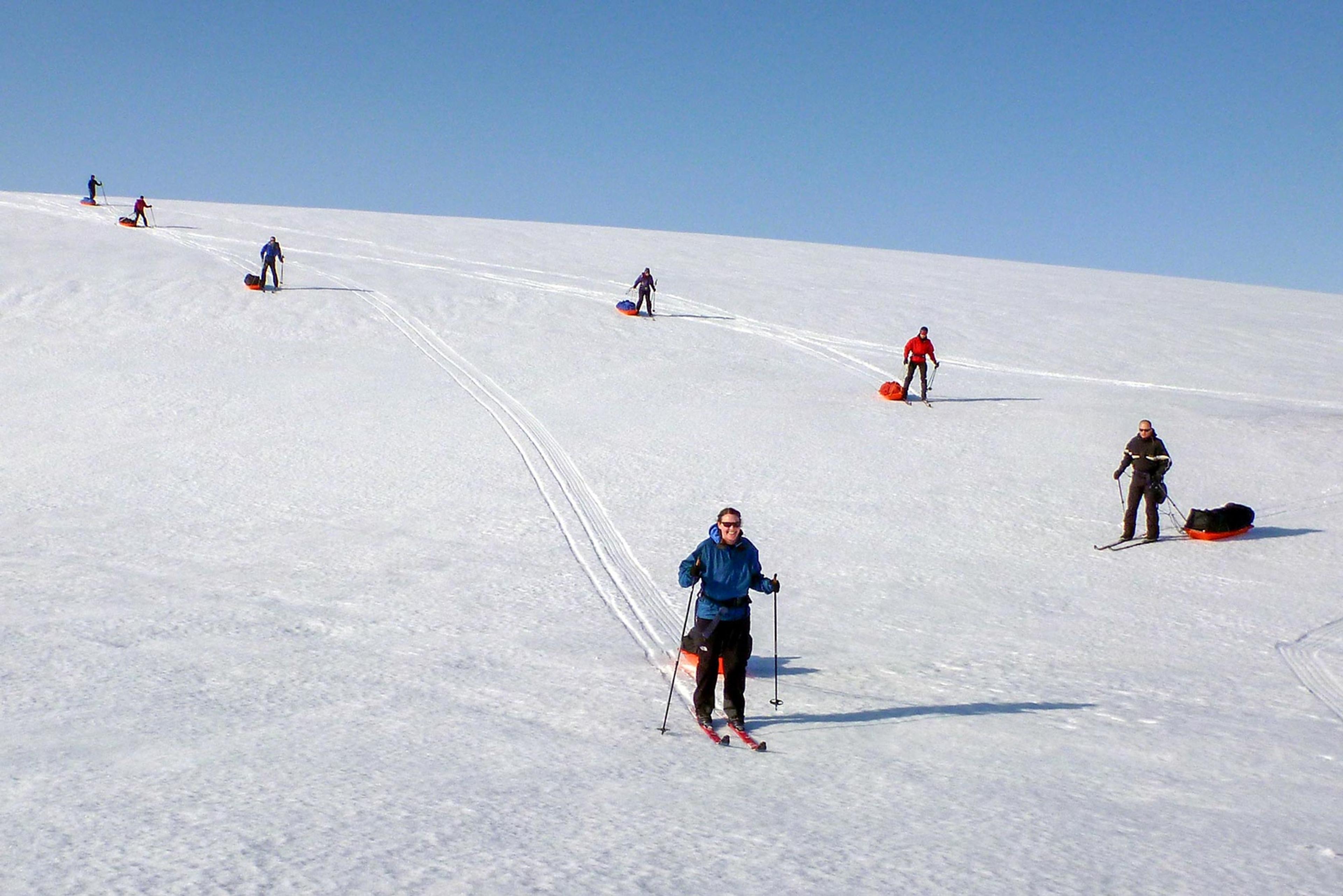 Skiers going down a slope on their way across Iceland's highlands