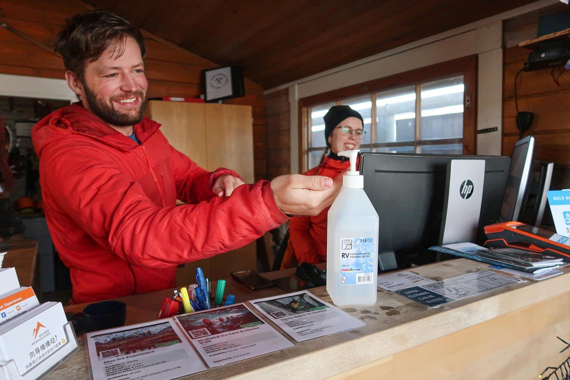 A guide disinfecting his hands before guiding a tour