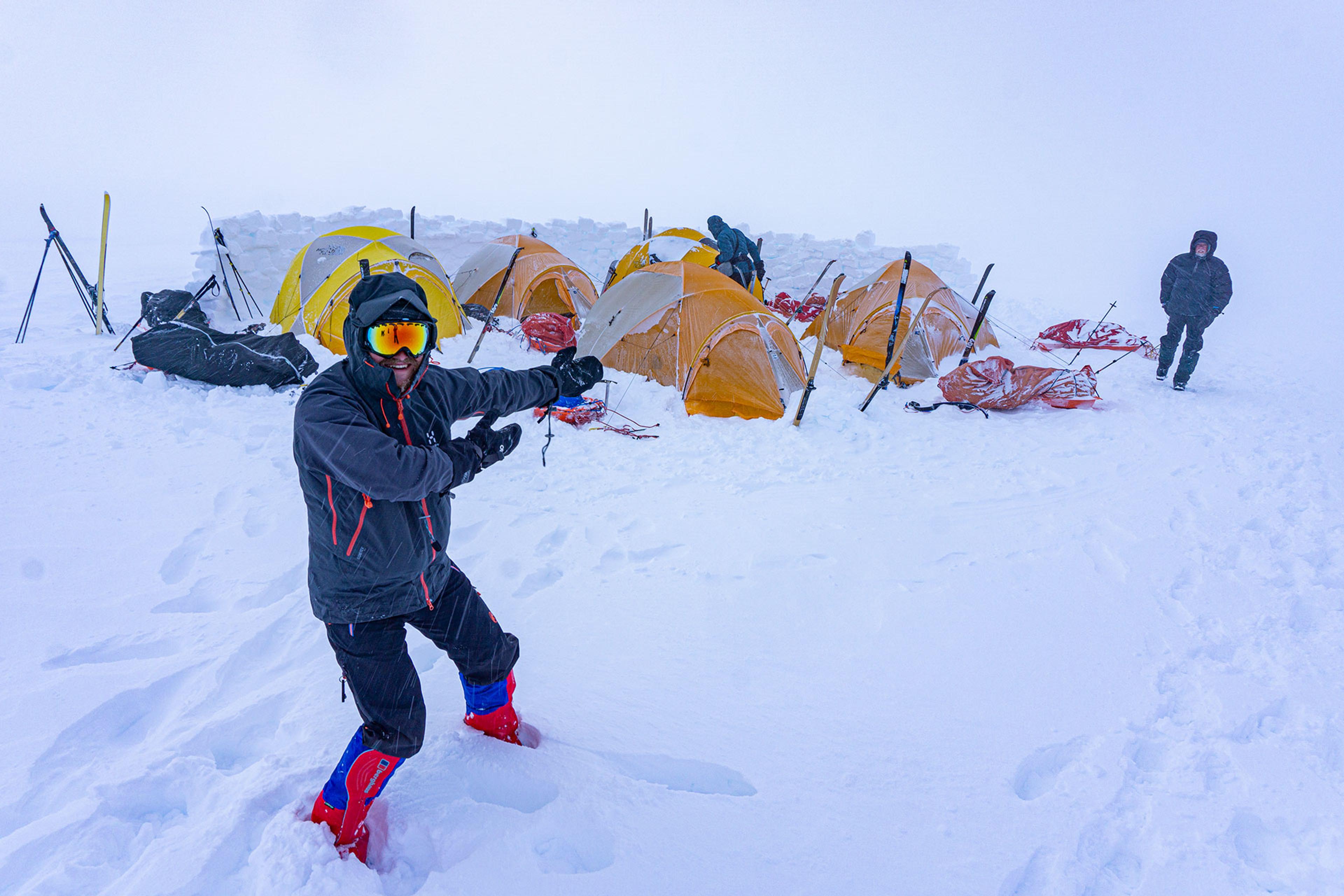 A guy very happy about the new established camp of fice tents and a wall around