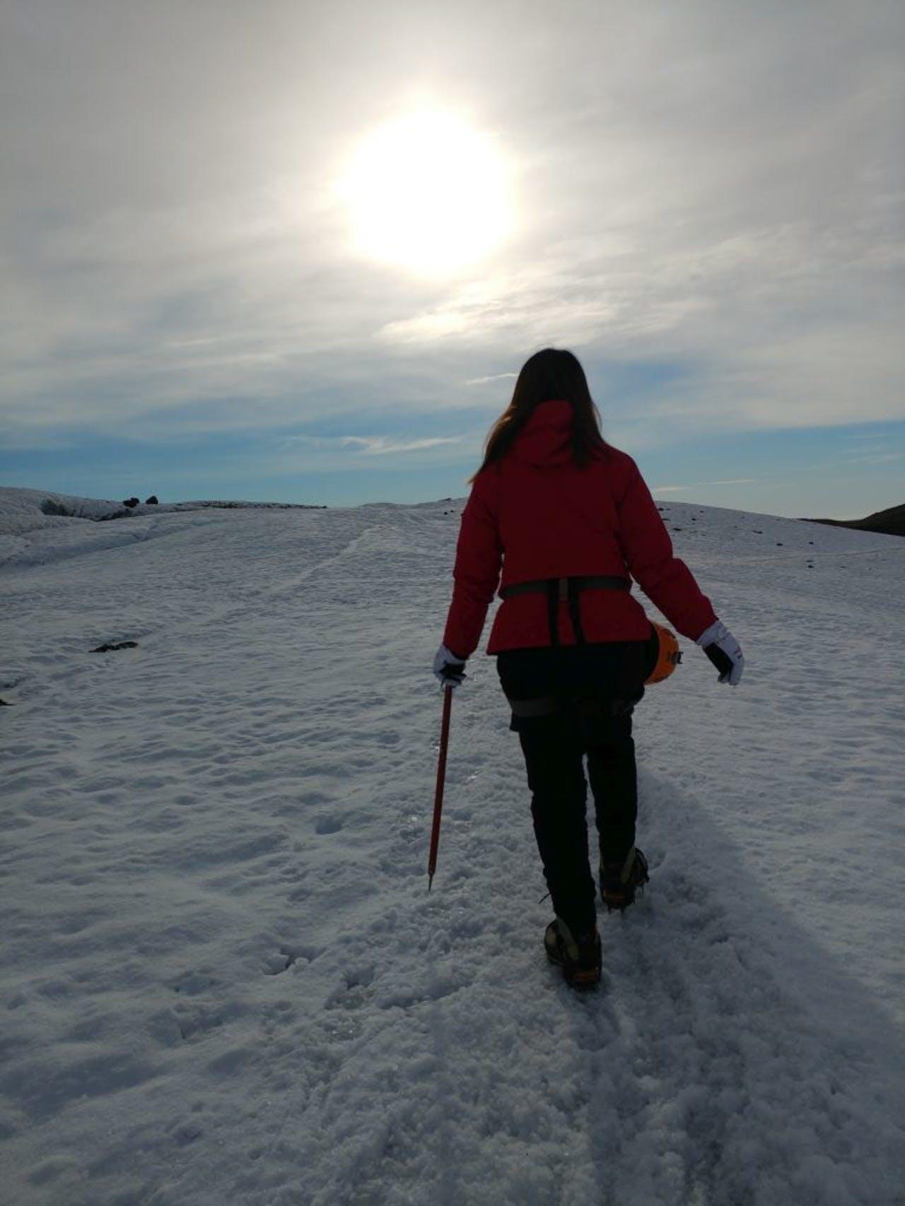 Woman hiking up a snowy slope