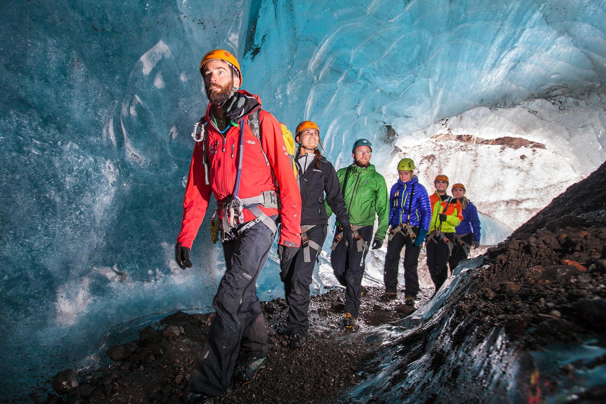 A guide from Icelandic Mountain Guides leading a group on a glacier walk in Iceland.
