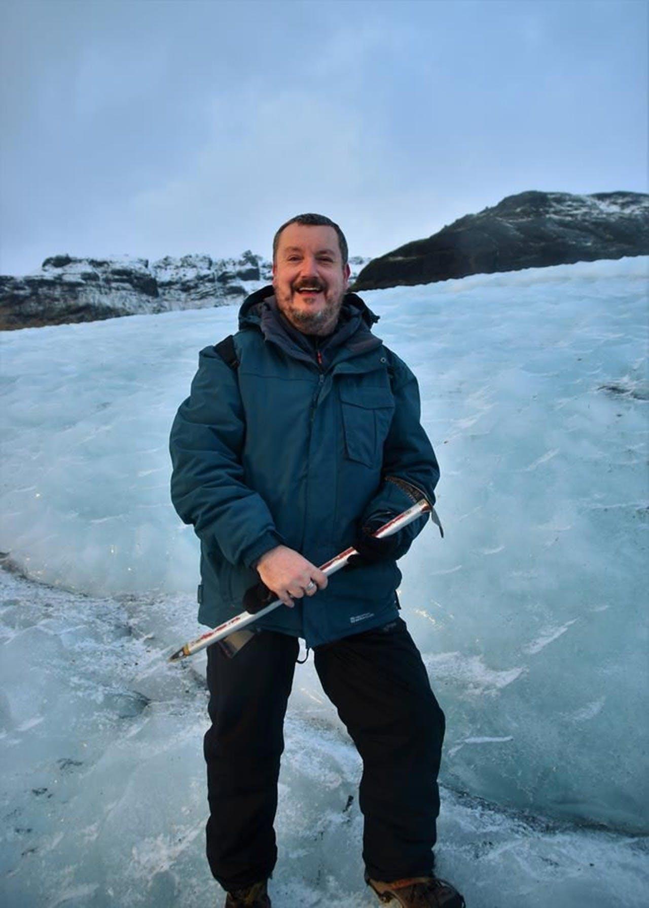 Man holding an iceax in Iceland