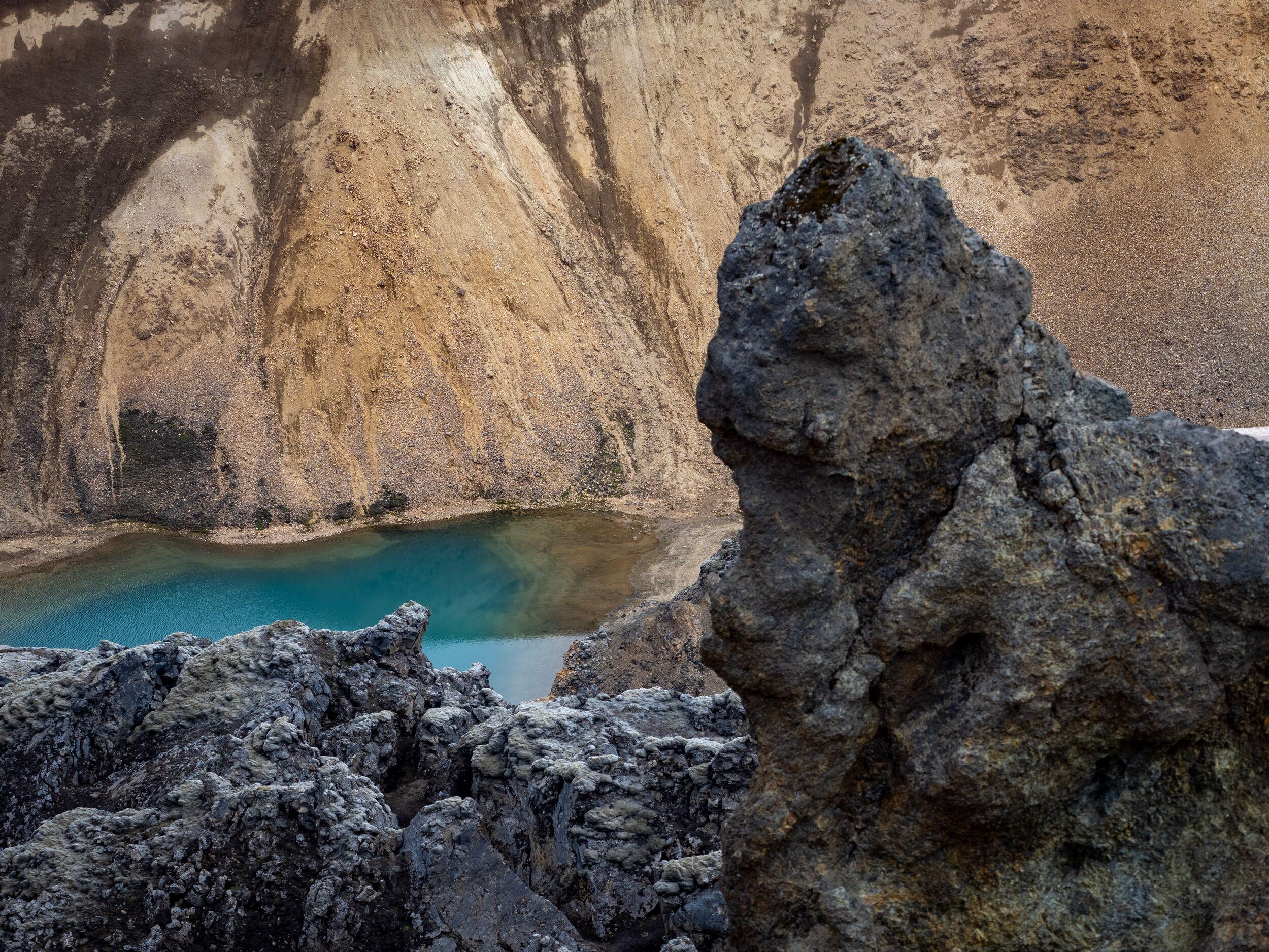 A blue lake or water-filled crater in the lava fields of the Icelandic highlands