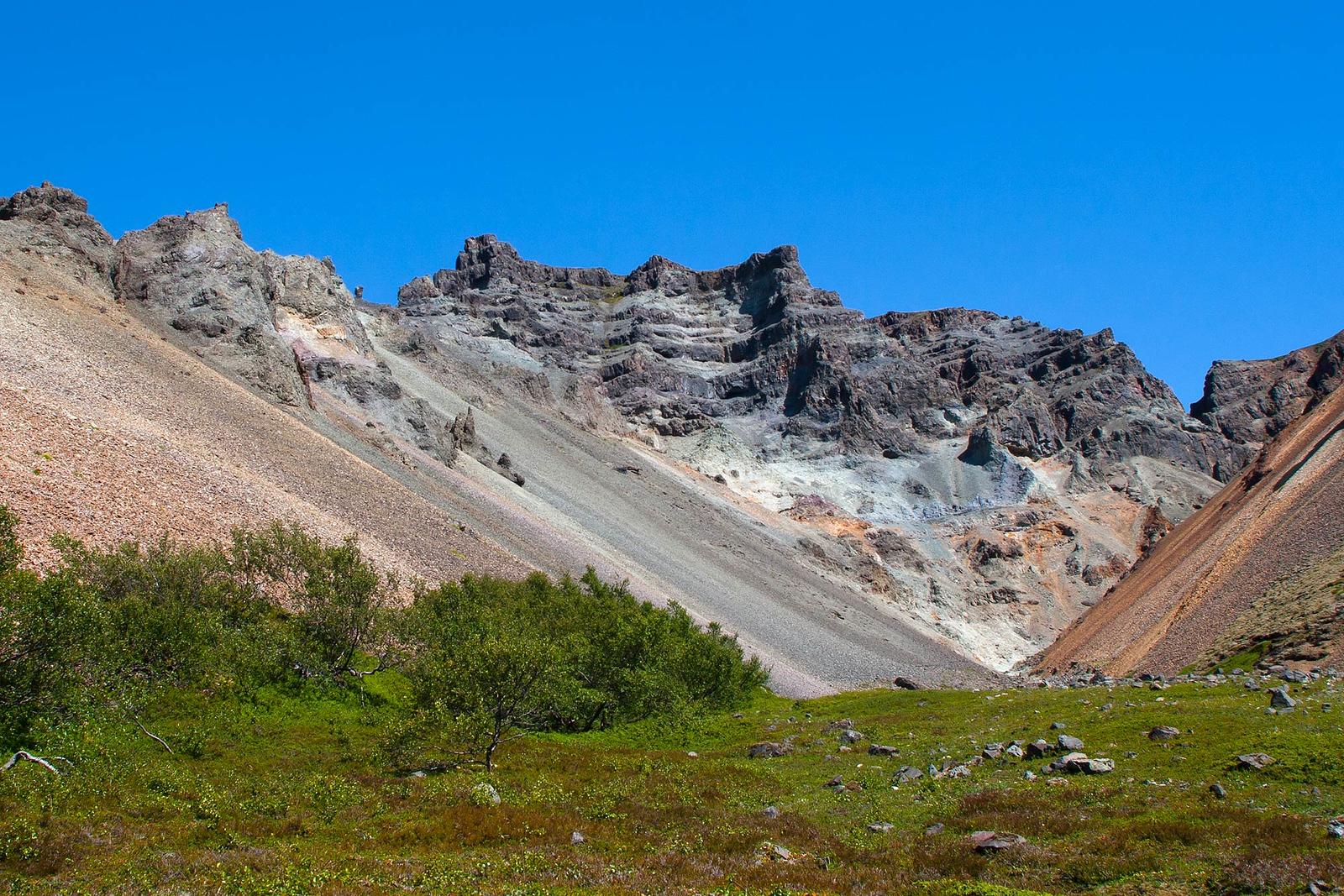 Red and gray mountains underneath the blue sky