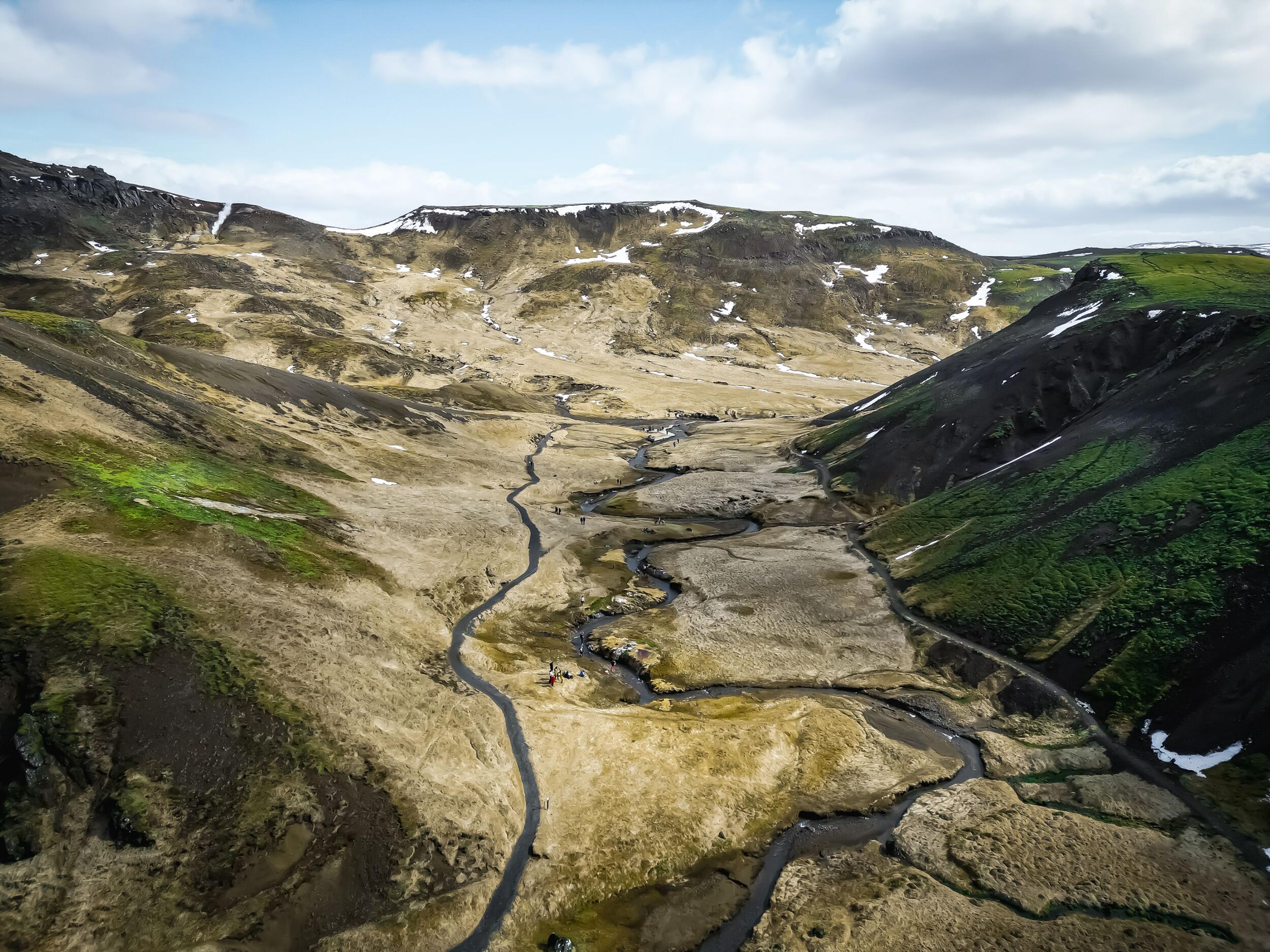 a valley with warm stream and a walking path
