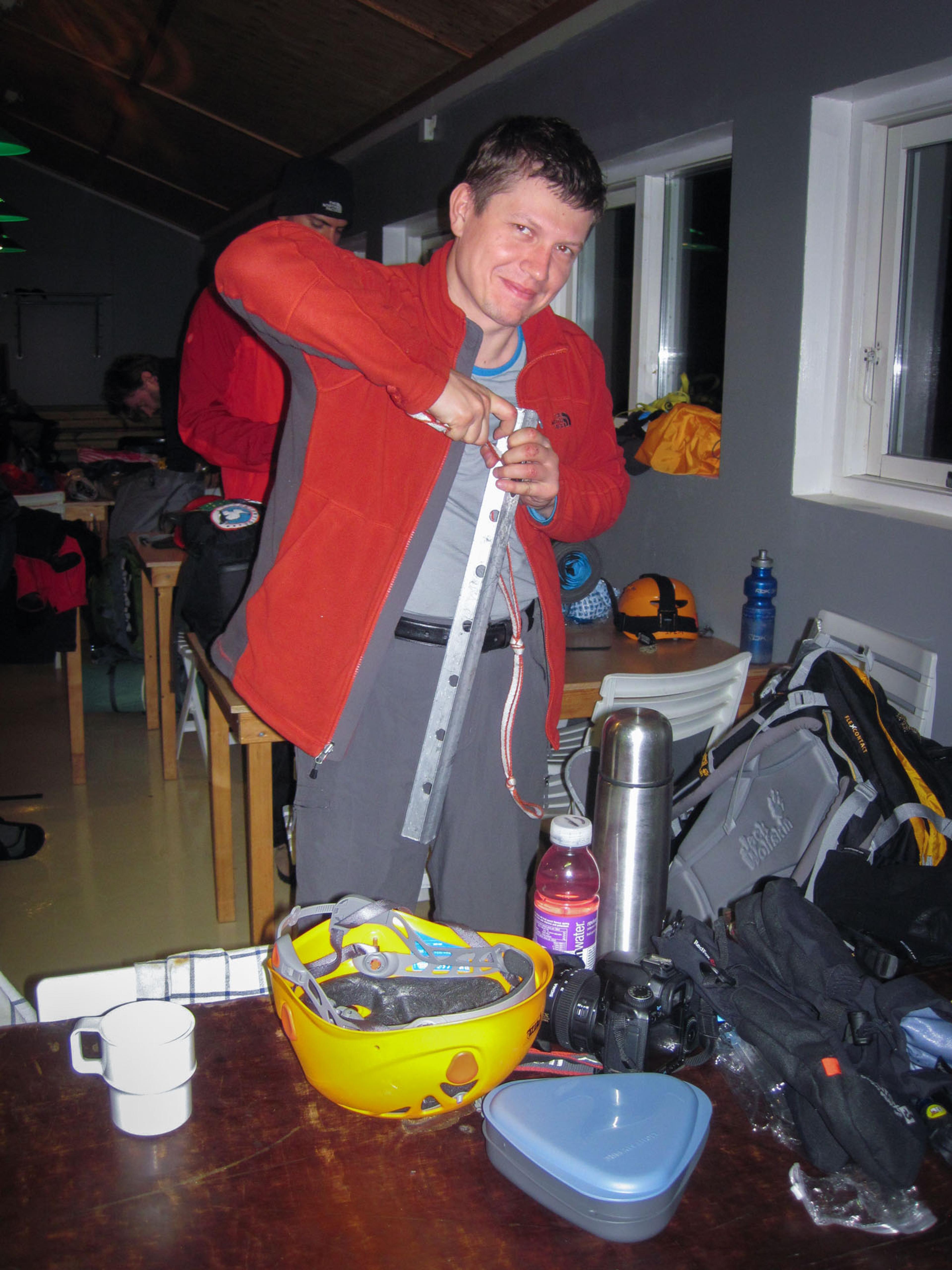 A man looking at the mountain climbing gear inside