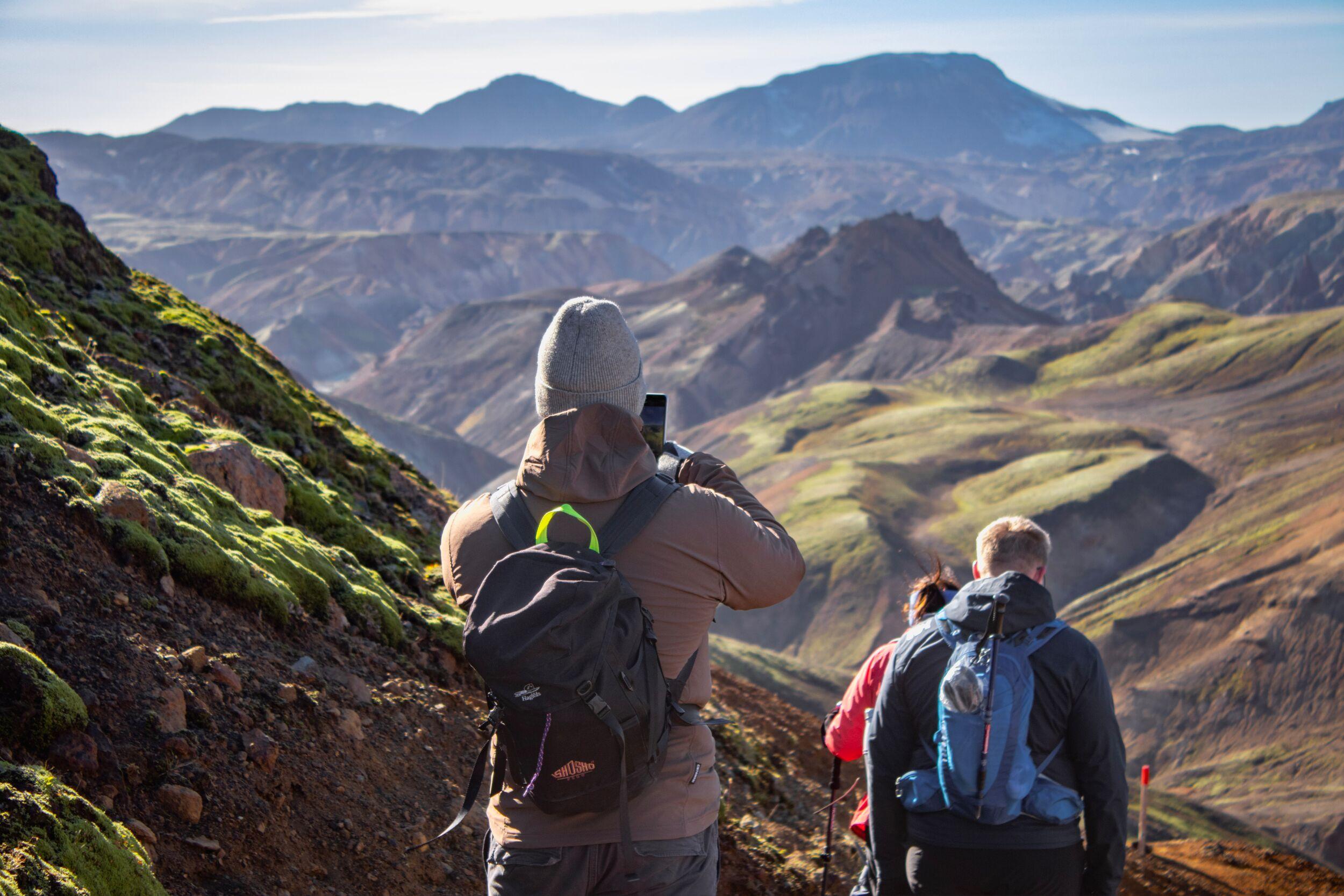People hiking to Grænihryggur in the mountains