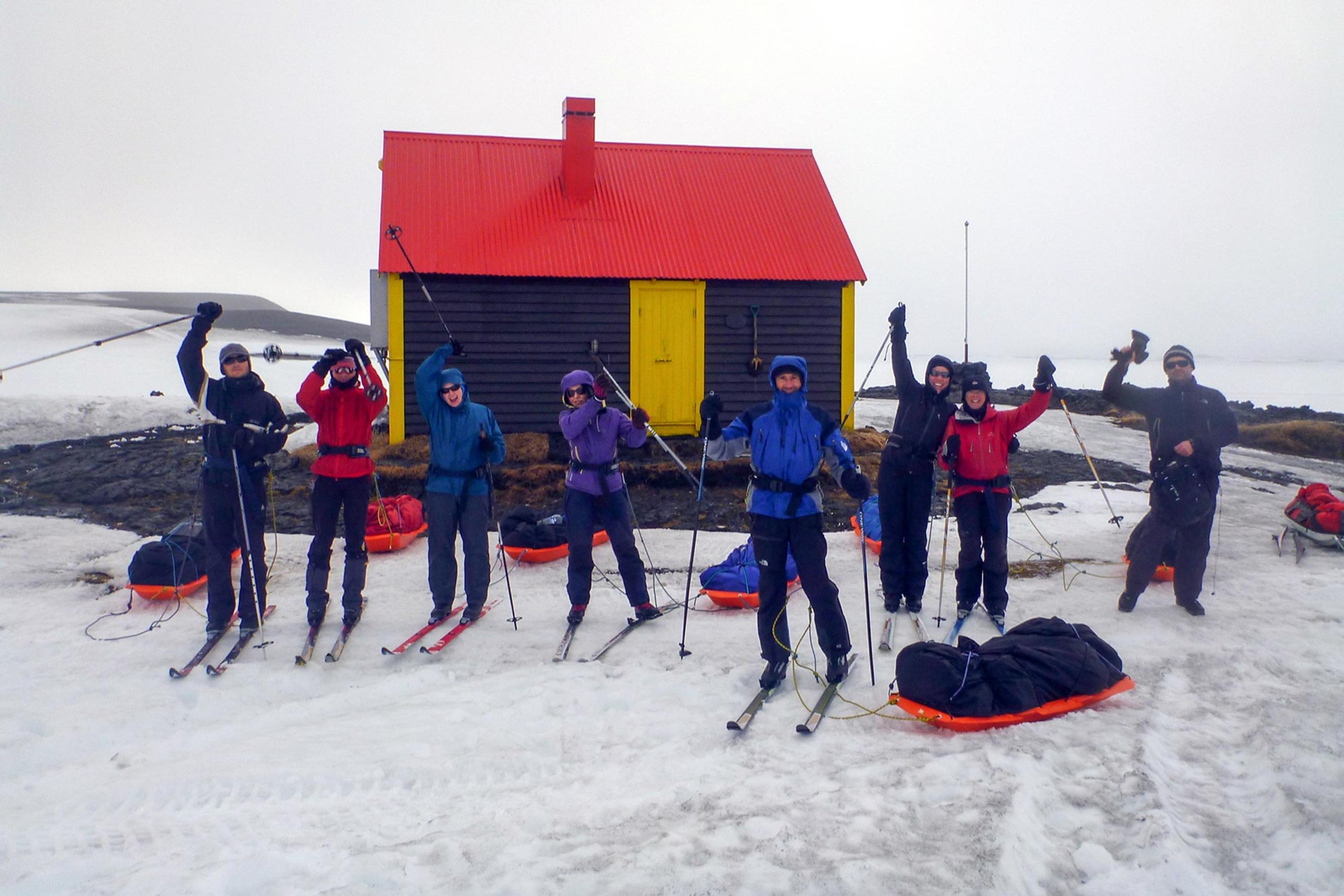 Expedition members in front of one of the huts in the highlands