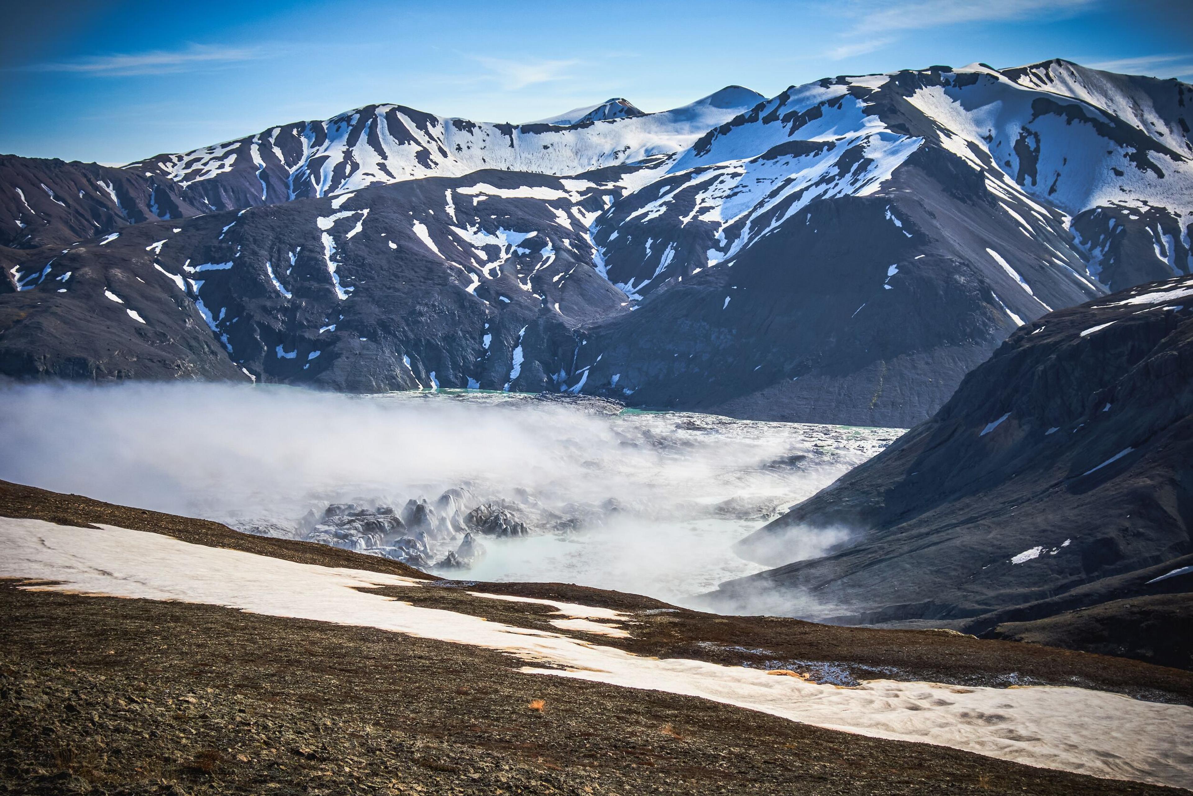 Snowcapped mountains in the background overlooking a glacier from the 5-Day Vatnajökull Wilderness Trek.