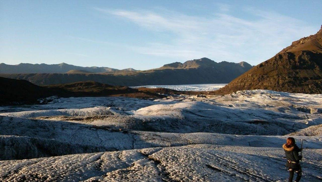 Girl standing on a glacier doing a glacier walk with Icelandic Mountain Guides