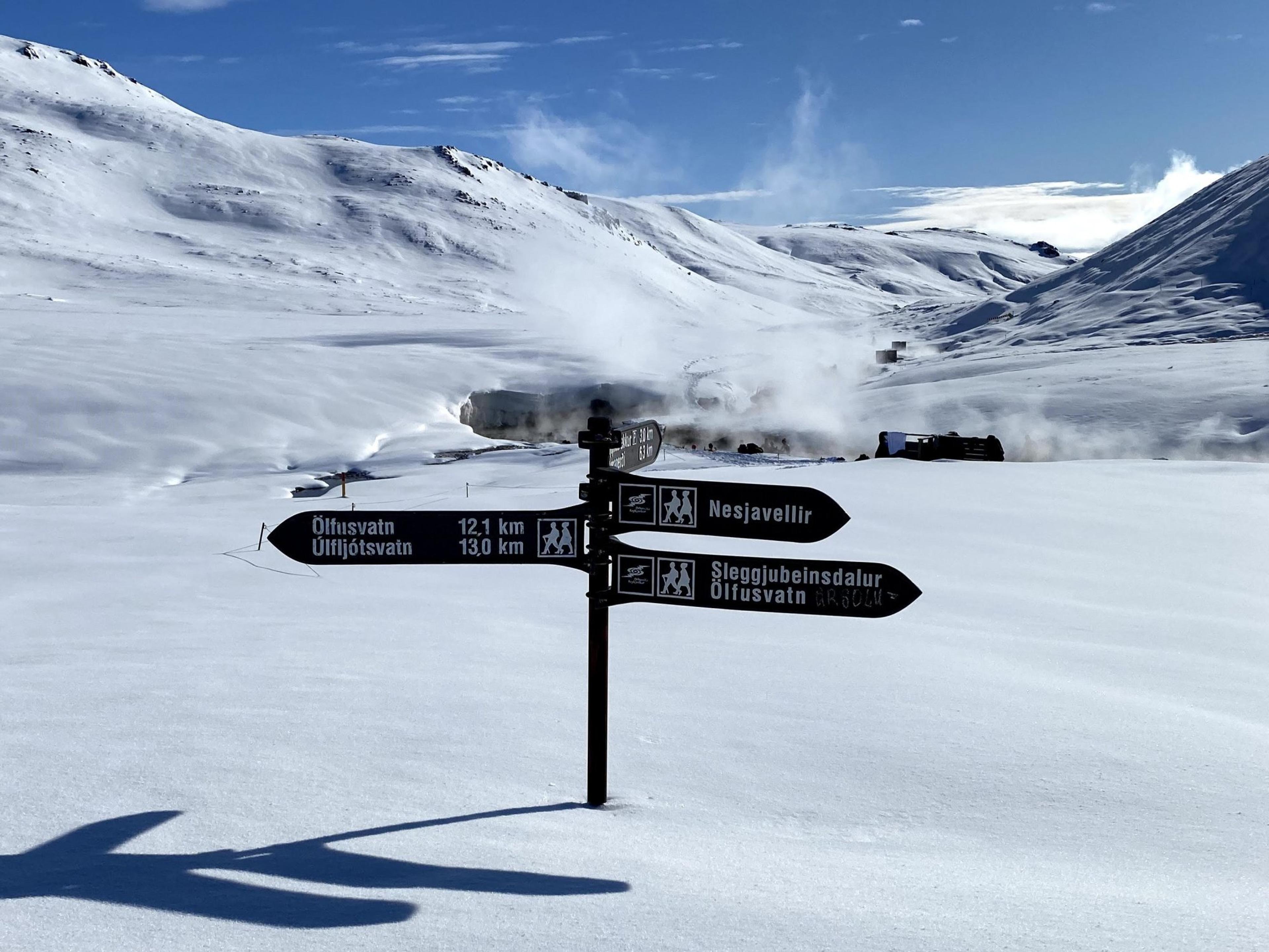 A signpost in Reykjadalur near hot springs during winter