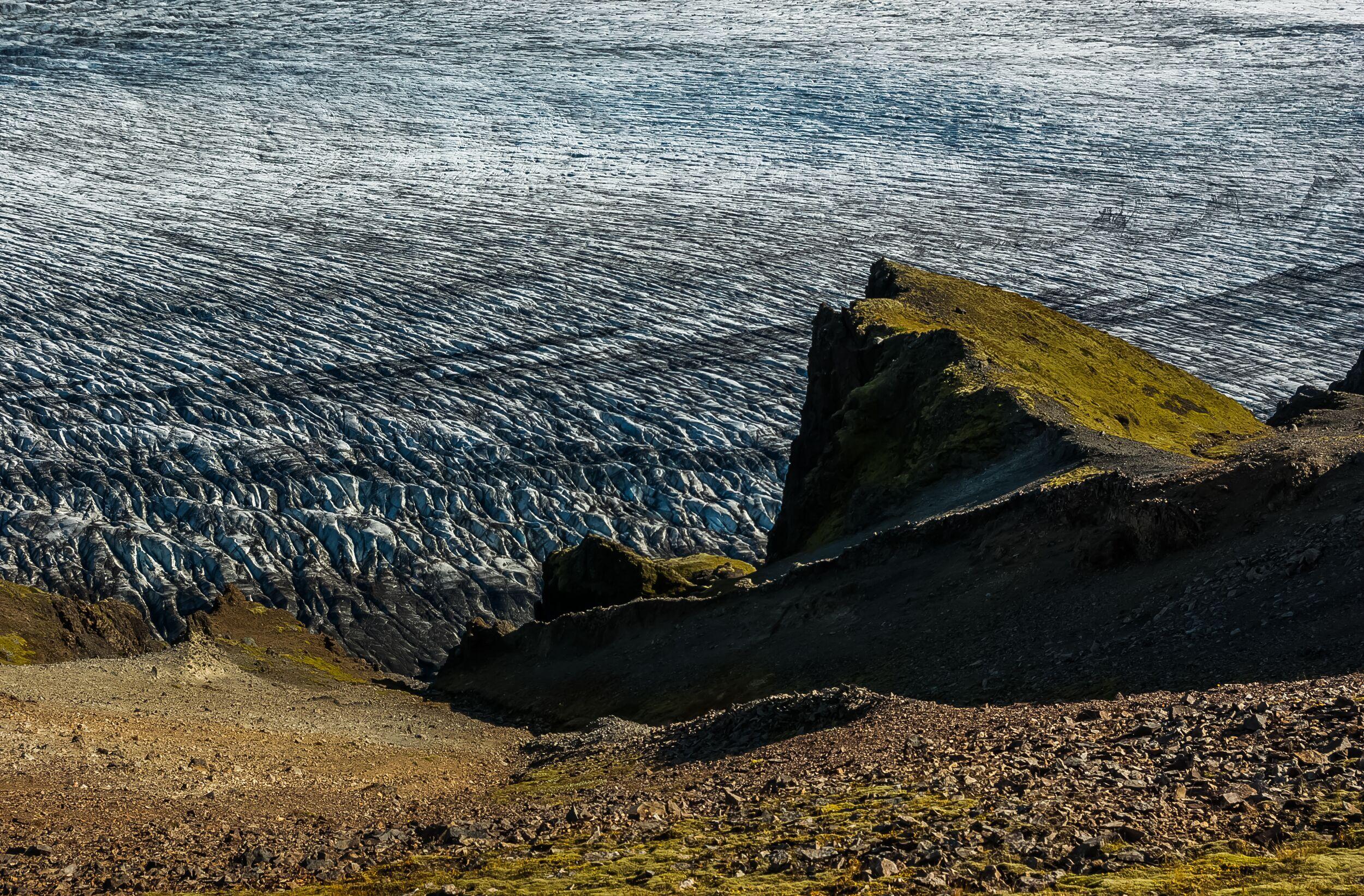 Steep, jagged cliffs along the Kristínartindar trail with dramatic drop-offs above the valley below.