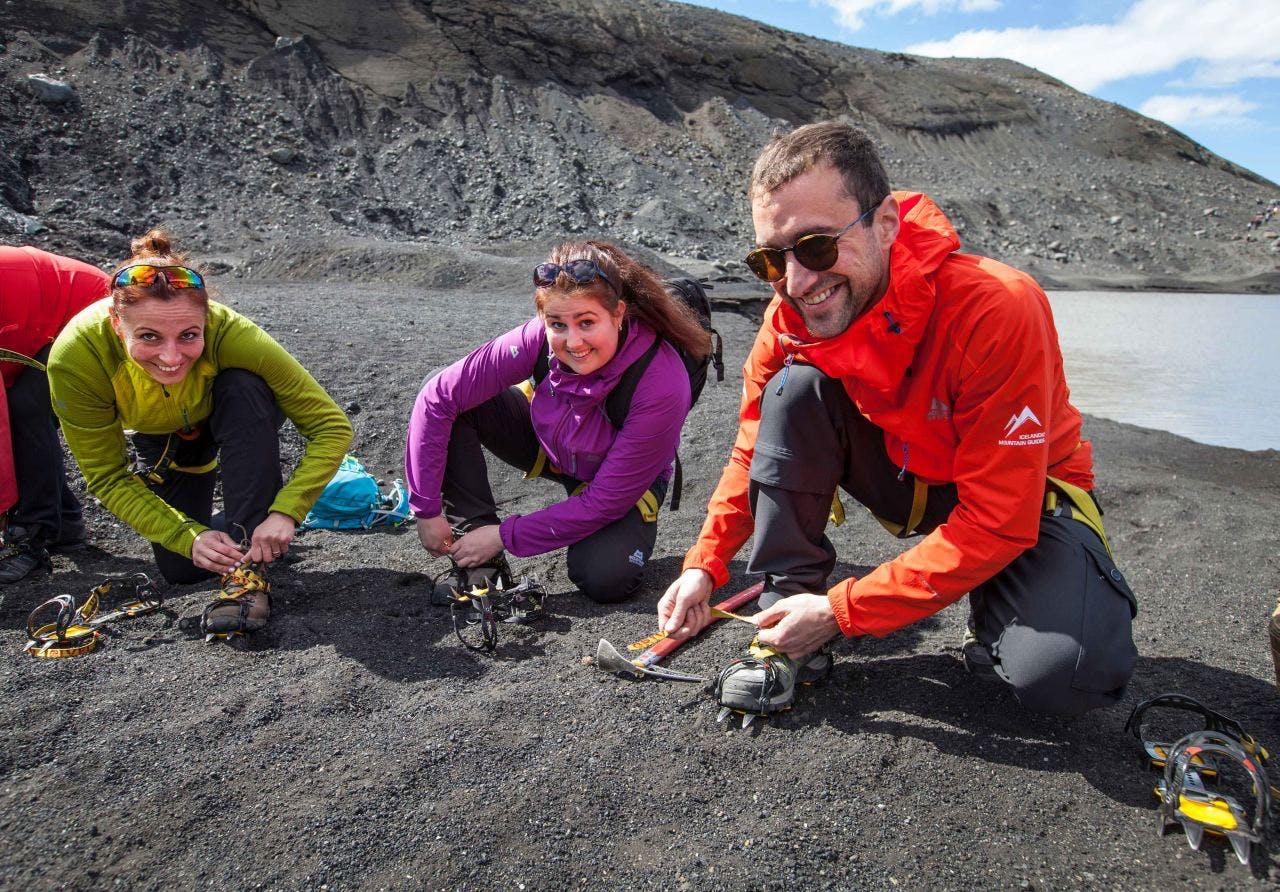 Getting those crampons on before a glacier walk tour on the Solheimajökull Glacier