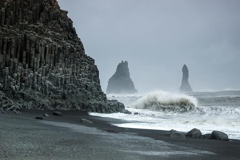 Reynisdrangar sea rocks and the black sand beach.