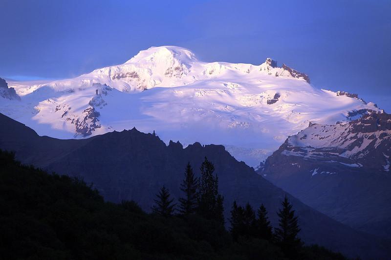 Snowy mountain under the blue morning sky.