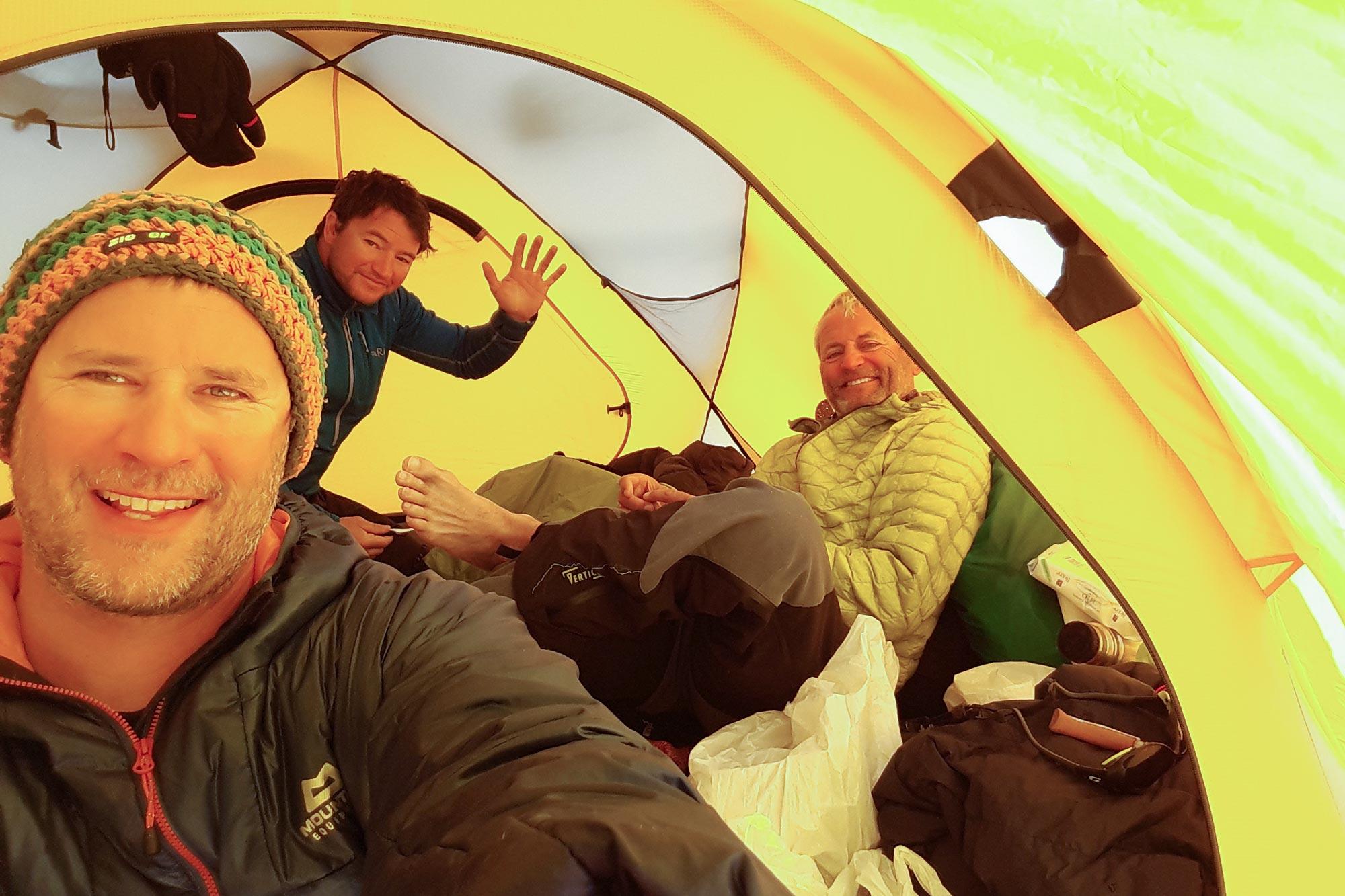 Three guys happy inside an expedition tent in Greenland