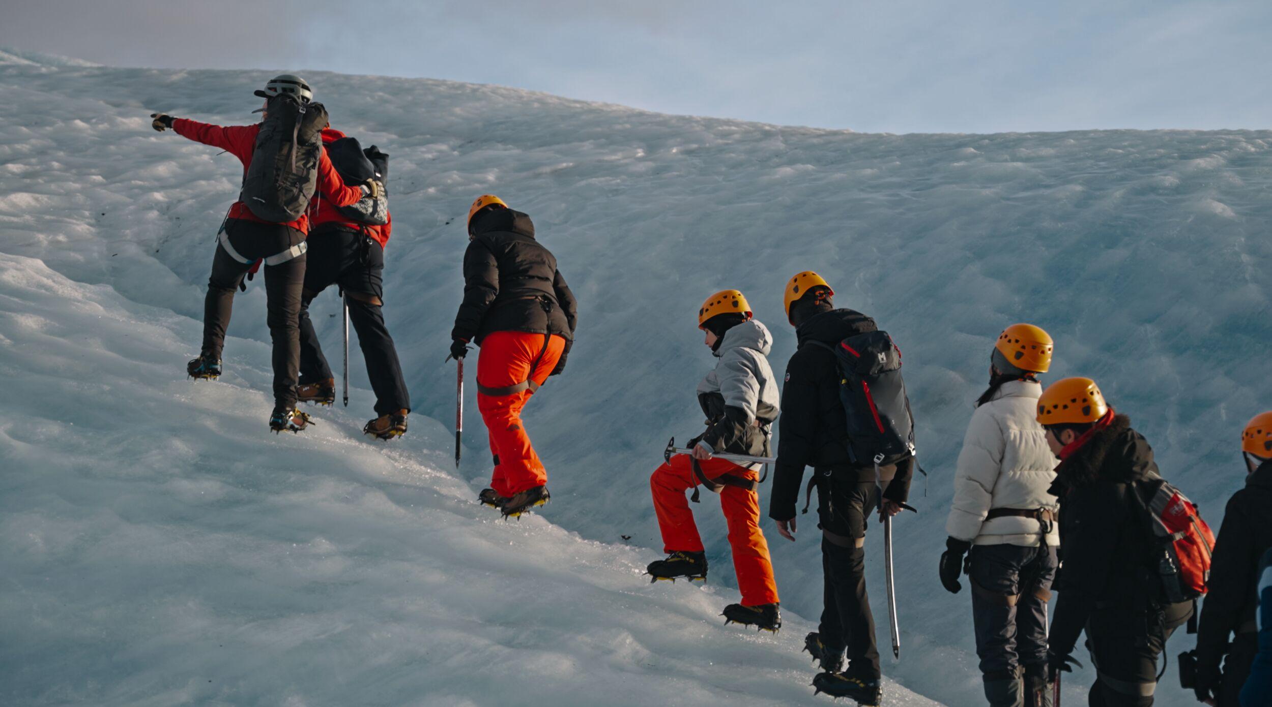 A group of hikers on a glacier, including a child