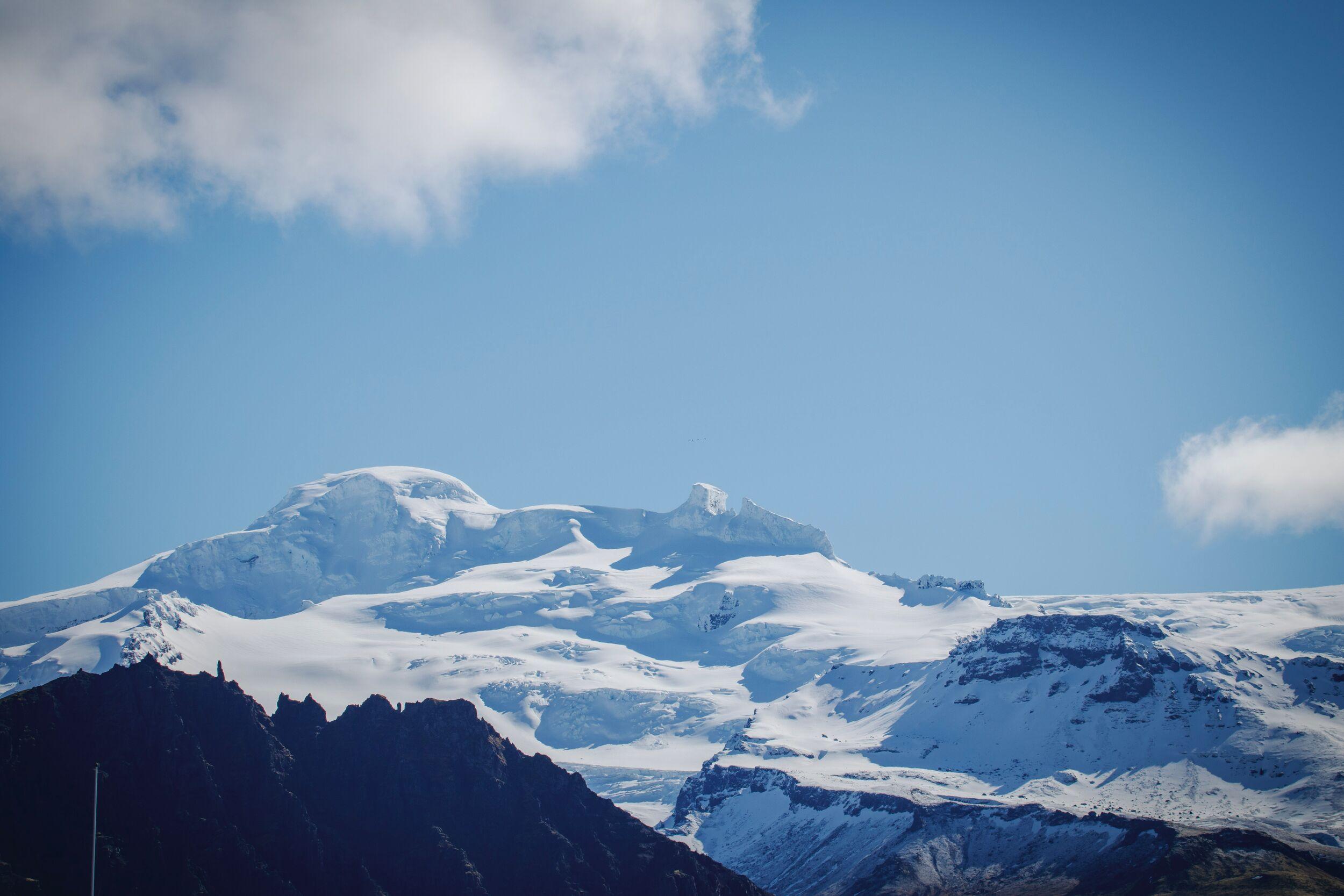 Snow-capped Hvannadalshnúkur peak with clear blue skies in the background