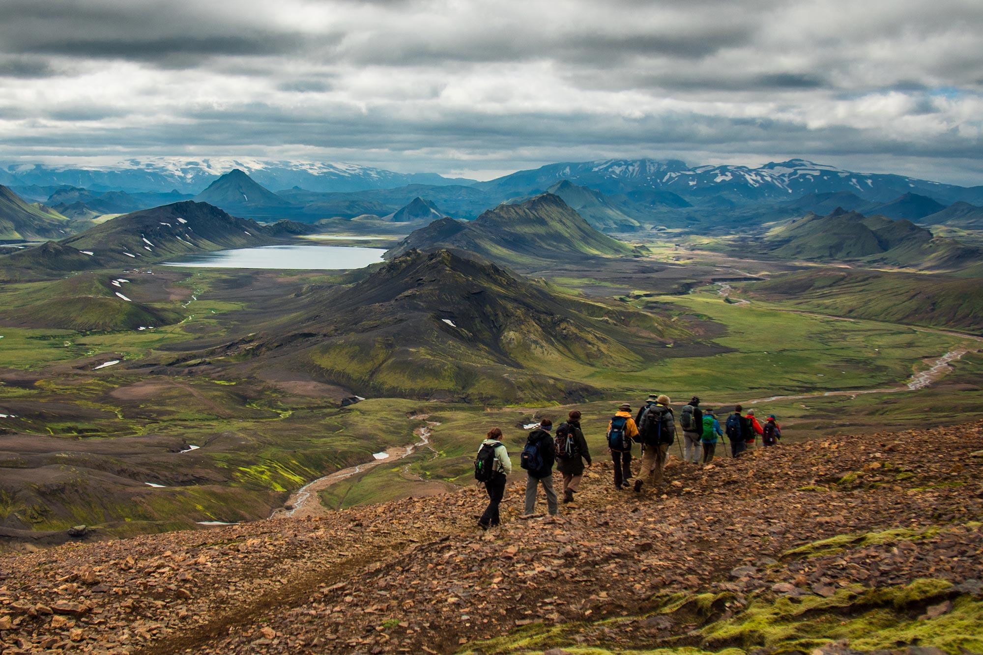 A group of people hiking down Jokultungur on the Laugavegur trail.