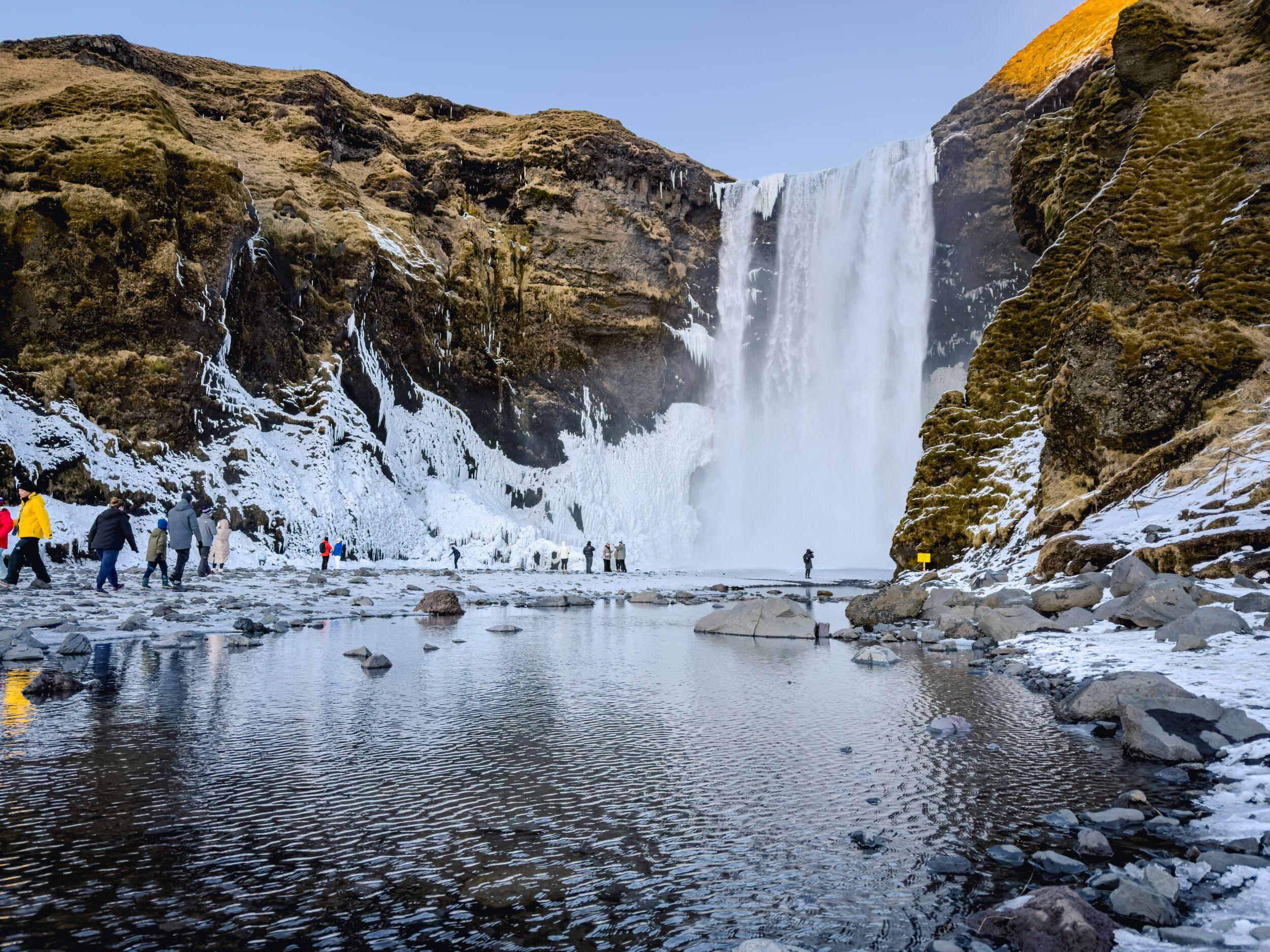 Skógafoss waterfall in winter covered with ice and snow