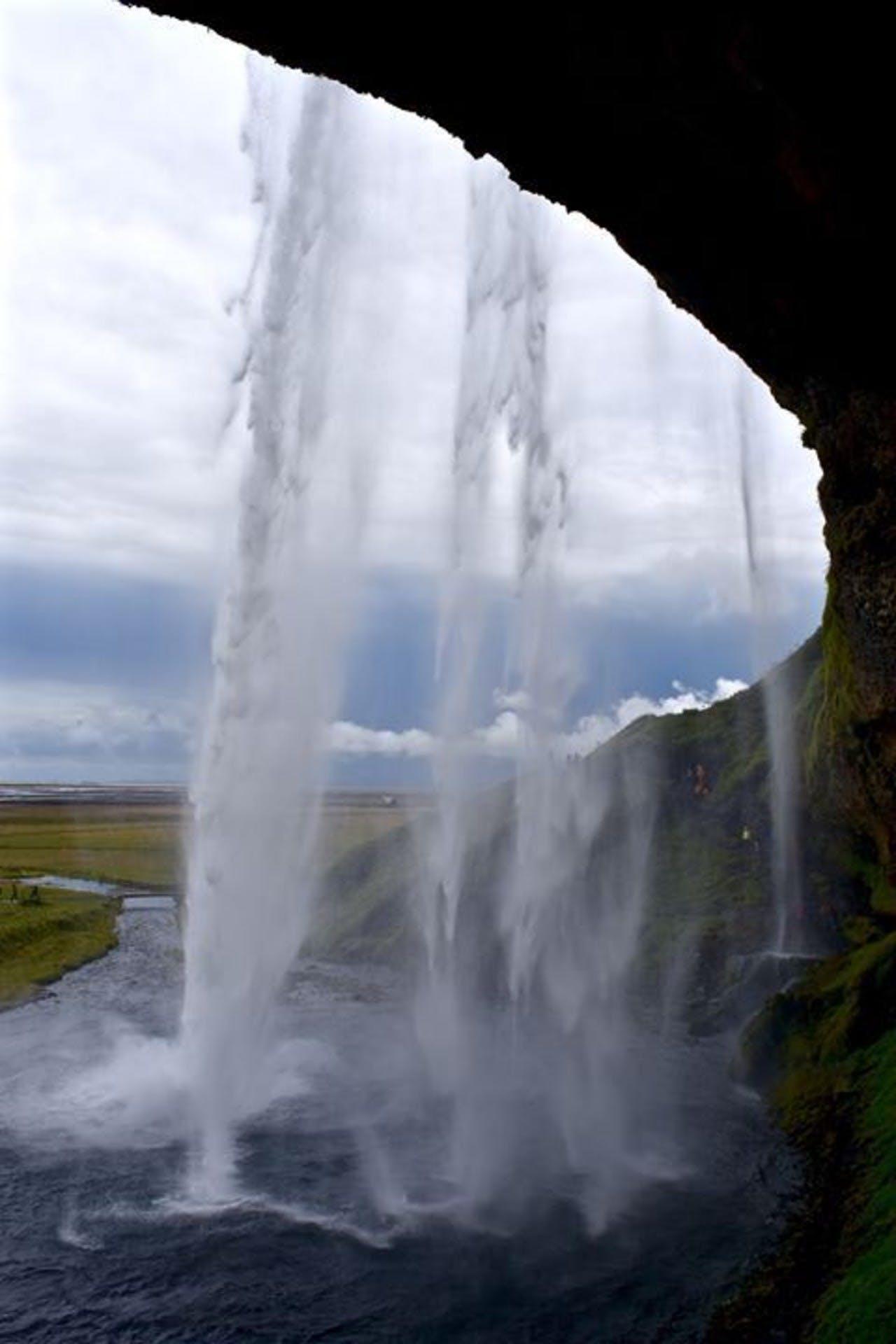 view from behind Seljalandsfoss waterfall