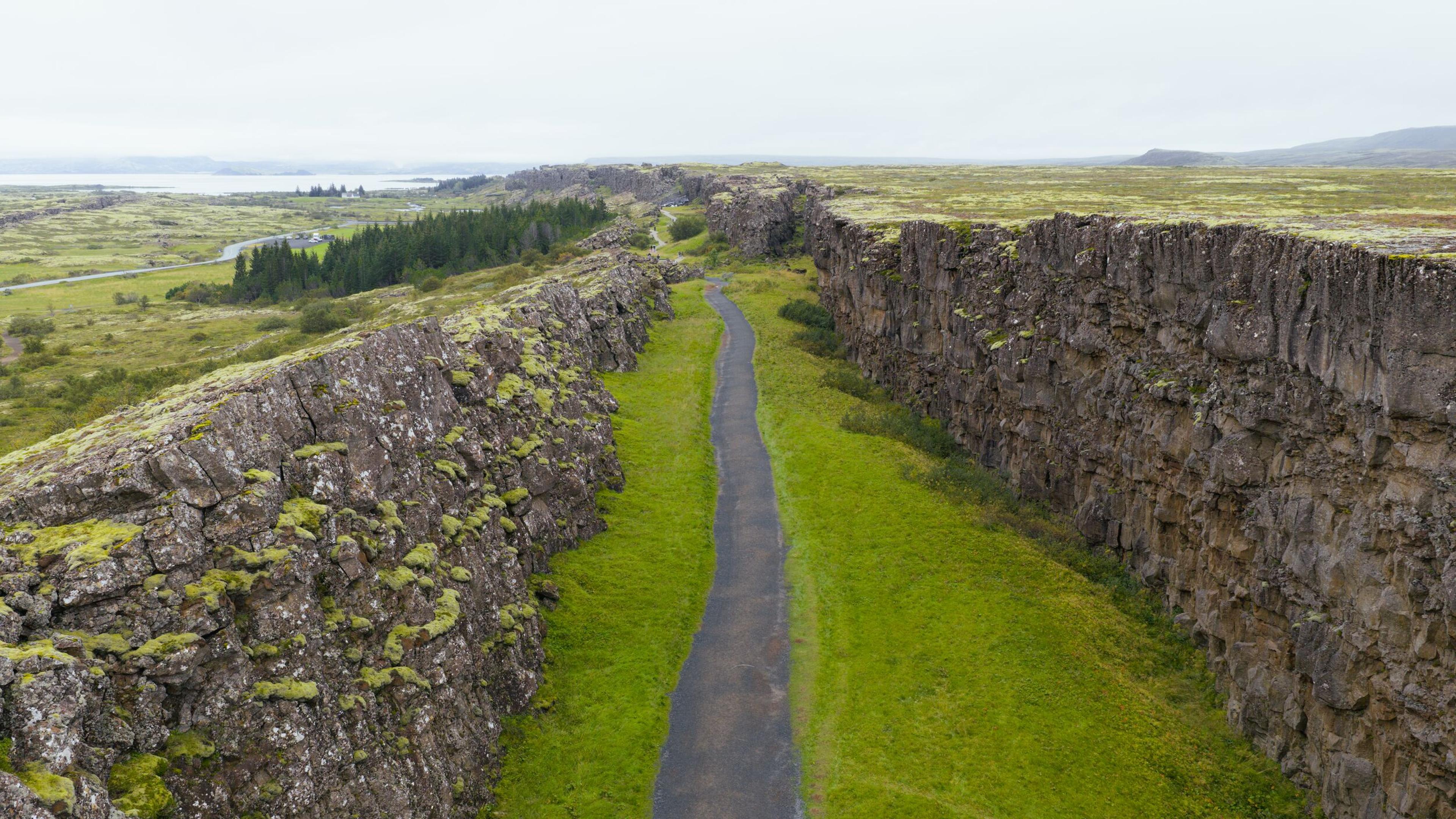 almannagja seen from above with a walking path and cliffs on each side