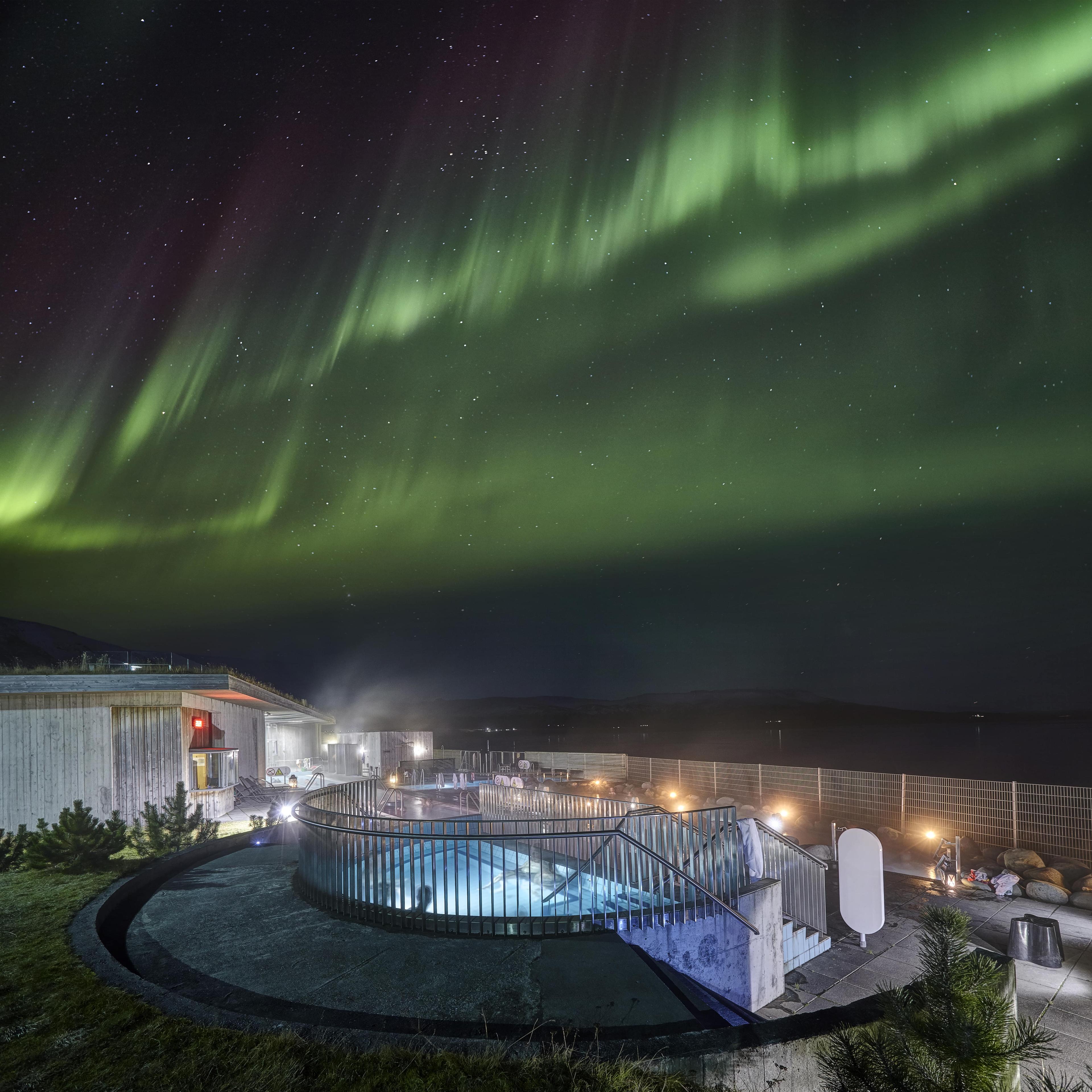 The northern lights above Fontana geothermal baths.