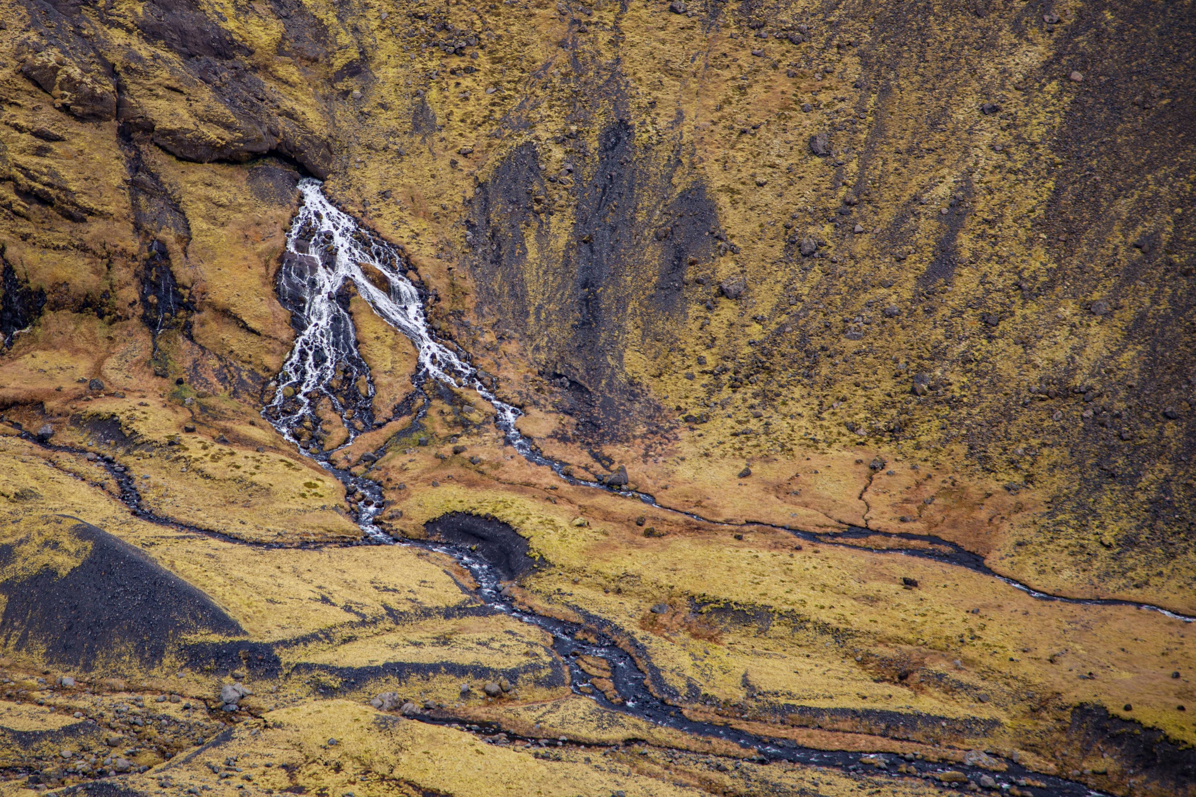 A spectacualar waterfall formed by water appearing in a middle of a slope