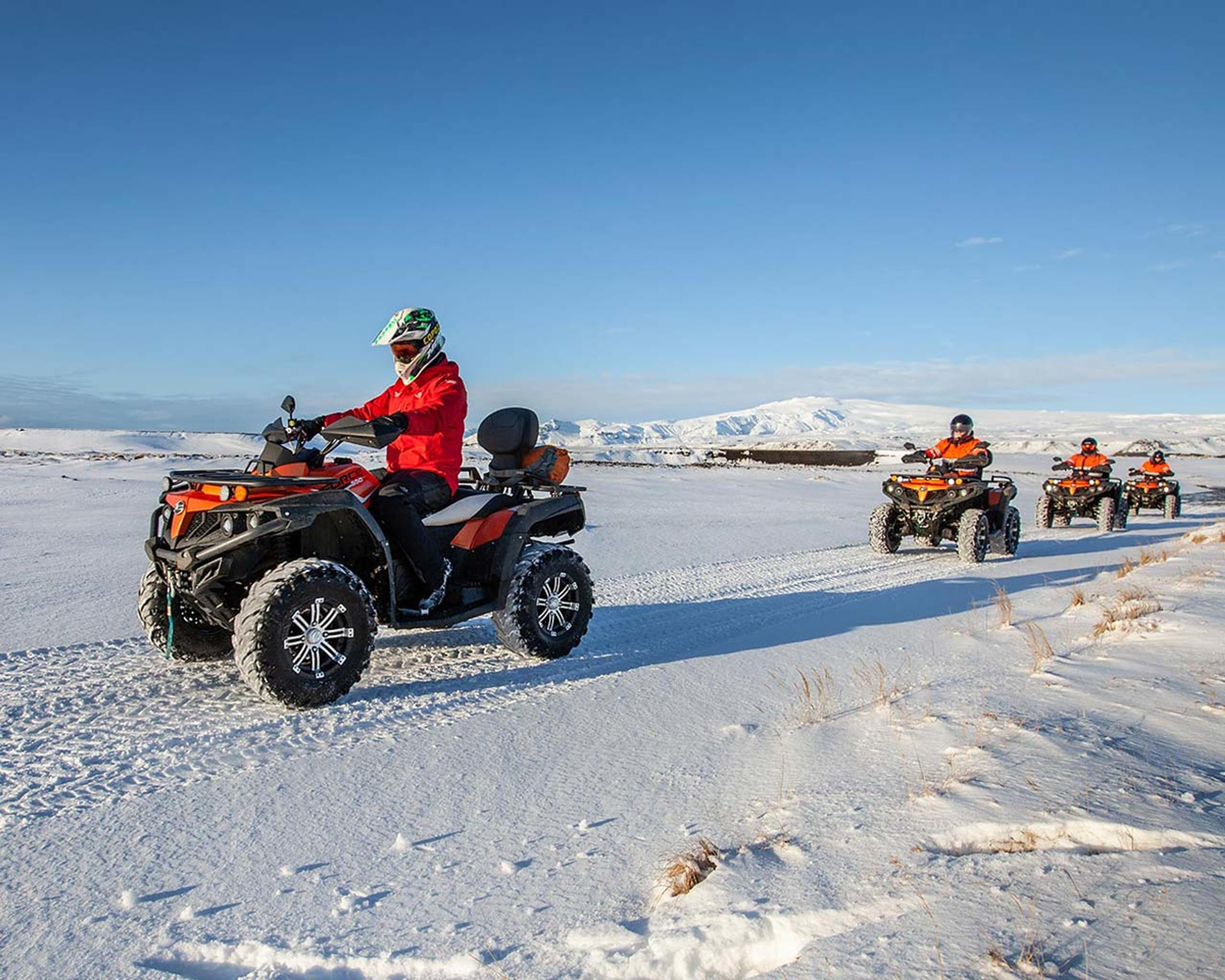 ATV quad bikes cruising over the snow covered tracks