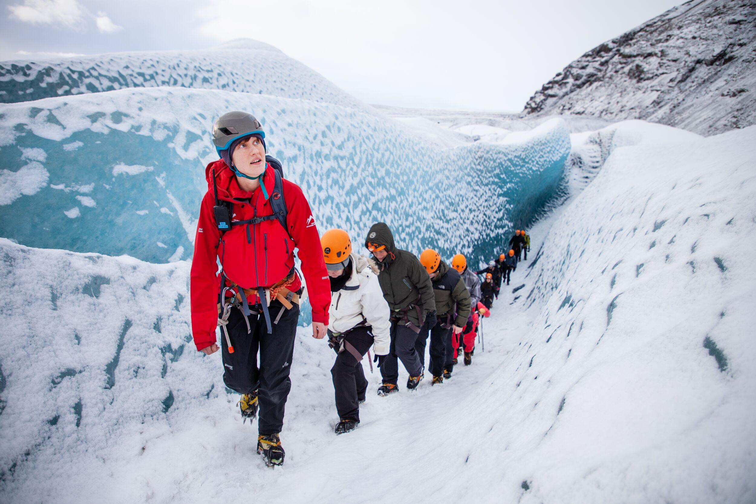 Group of people walking on a glacier