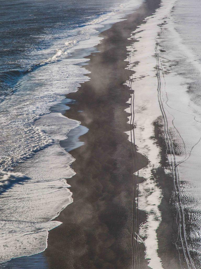 A birds view photo of a black sand beach in Iceland