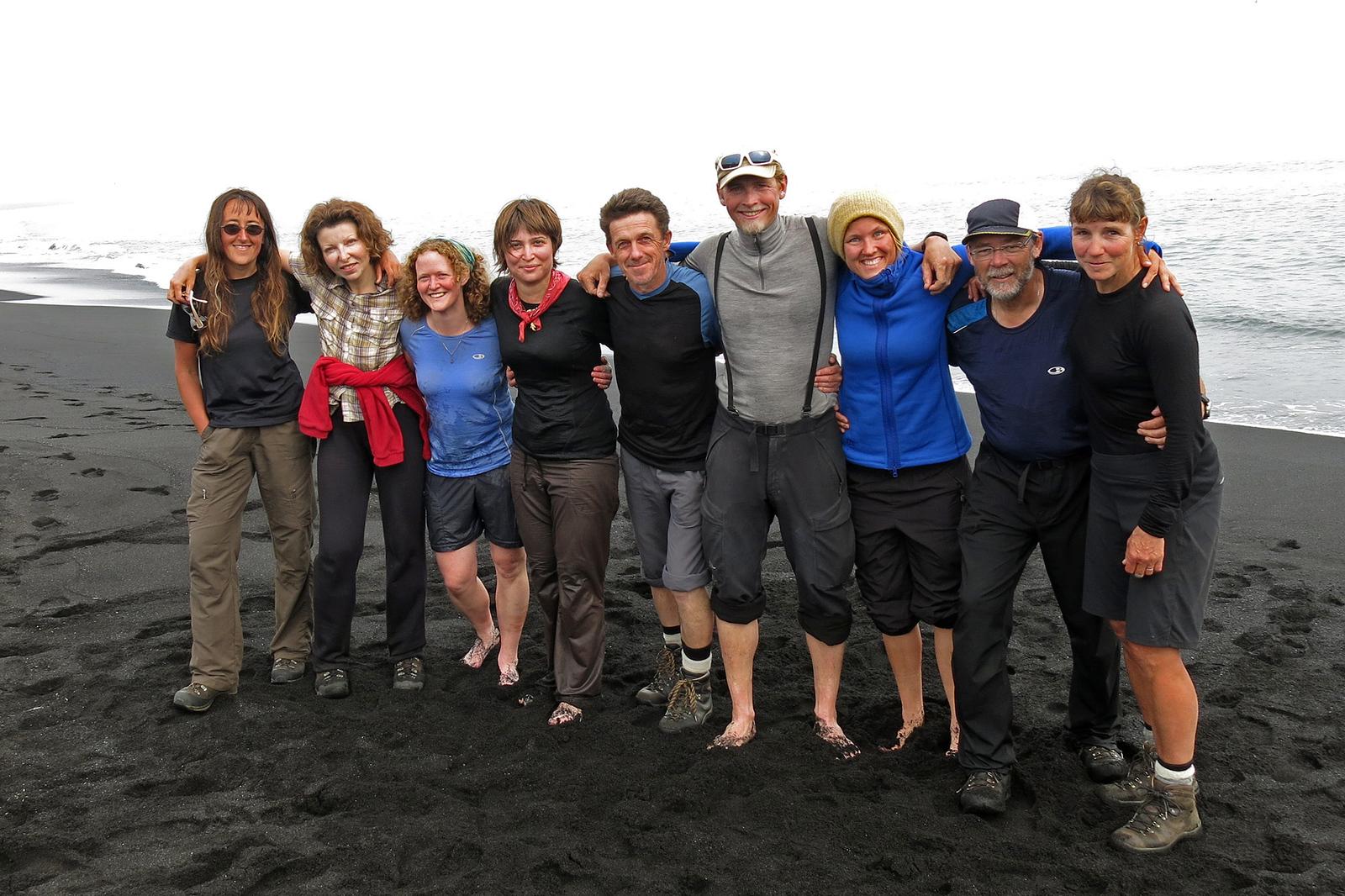 Happy explorers on a black sand beach