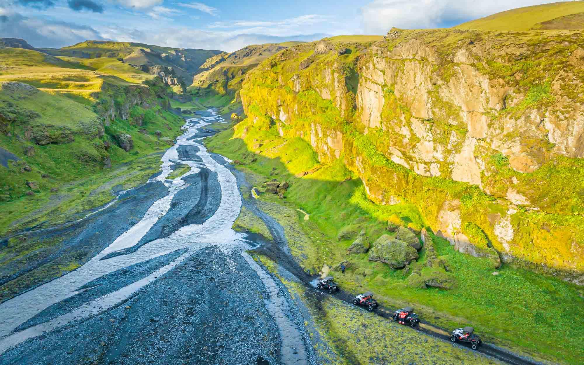 Aerial picture of buggies driving into a riverbed in iceland