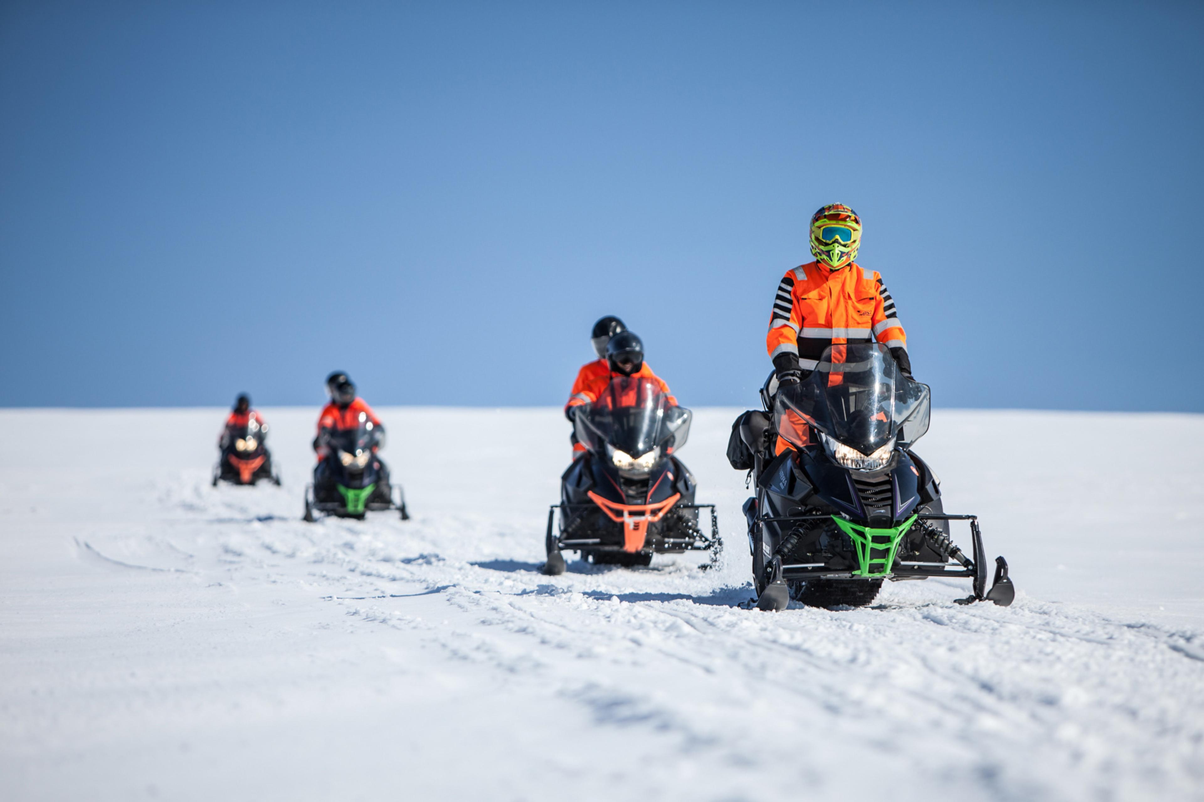 People on snow scooters driving on Mýrdalsjökull glacier