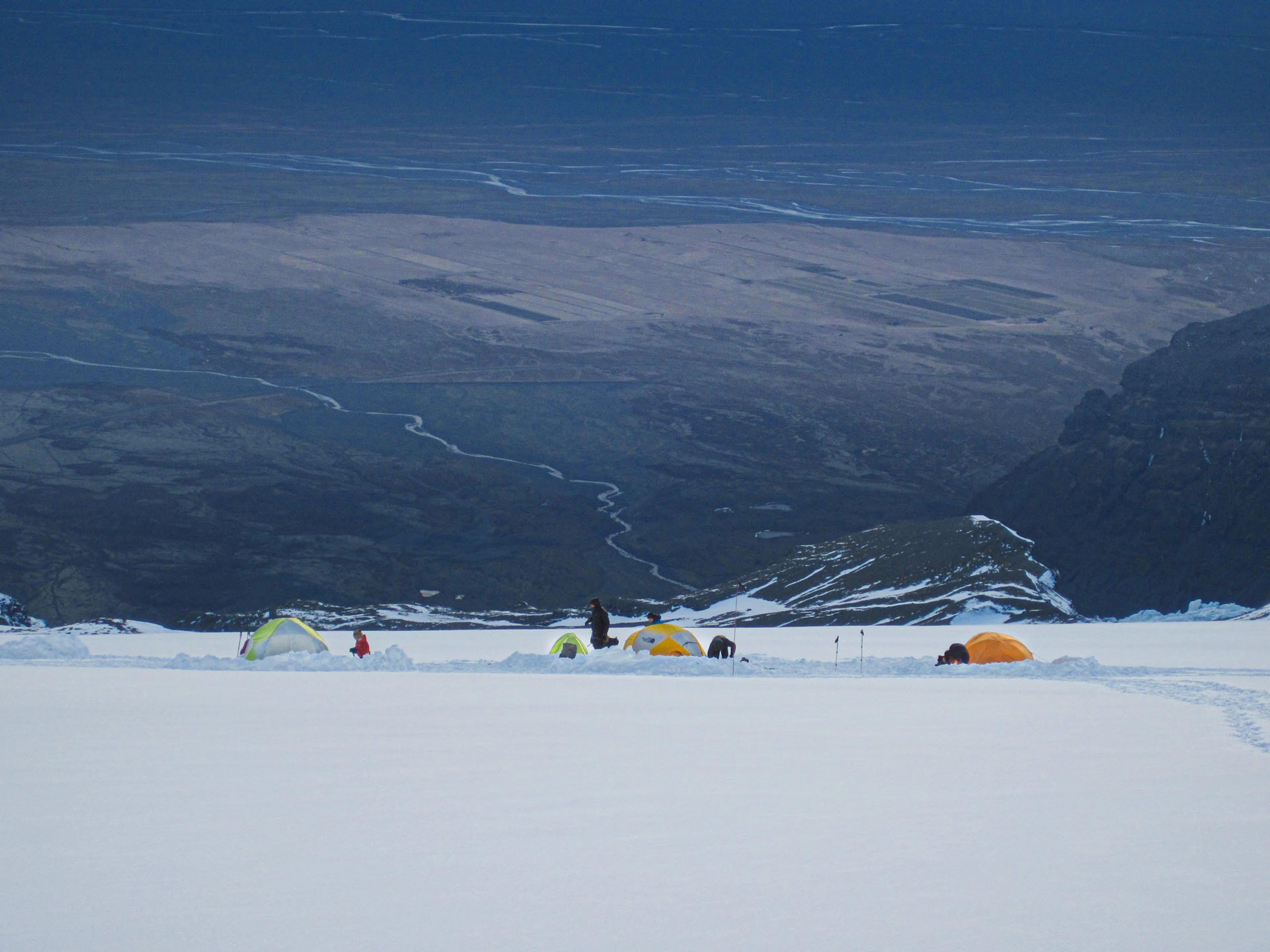 landscape view on a snowy mountain with tents 