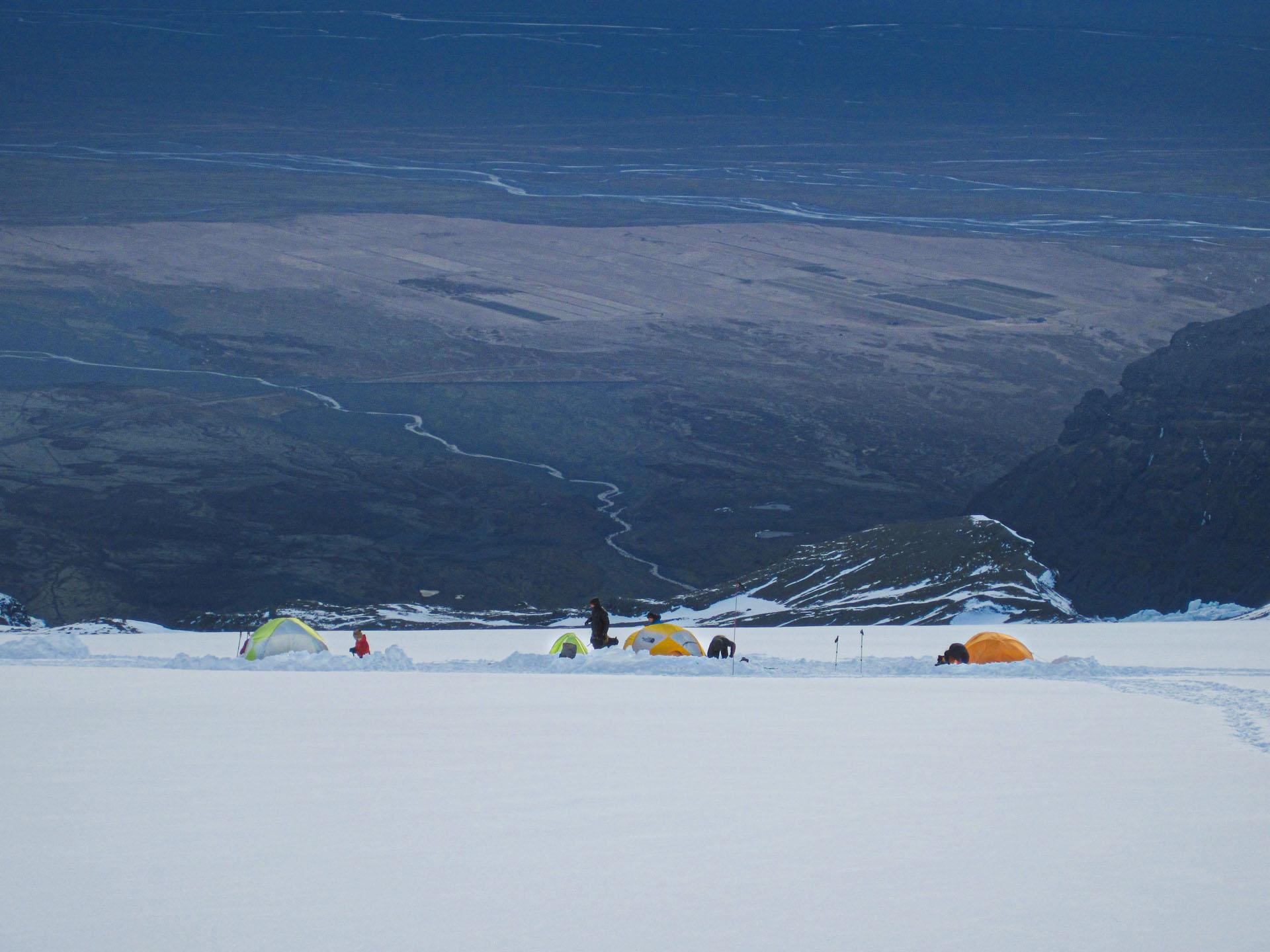 landscape view on a snowy mountain with tents