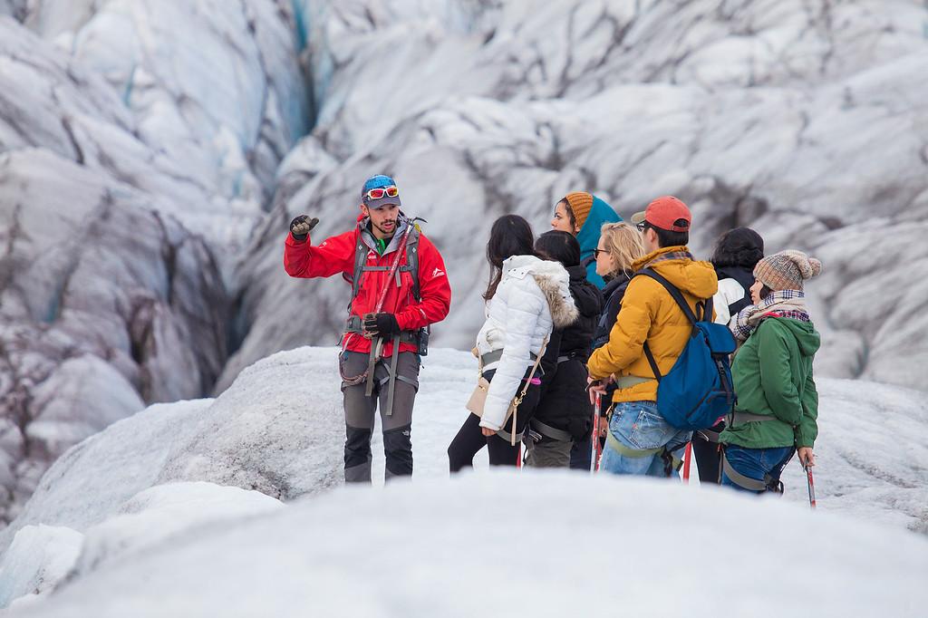 An Icelandic Mountain Guide talking to his crew members on a glacier walk.