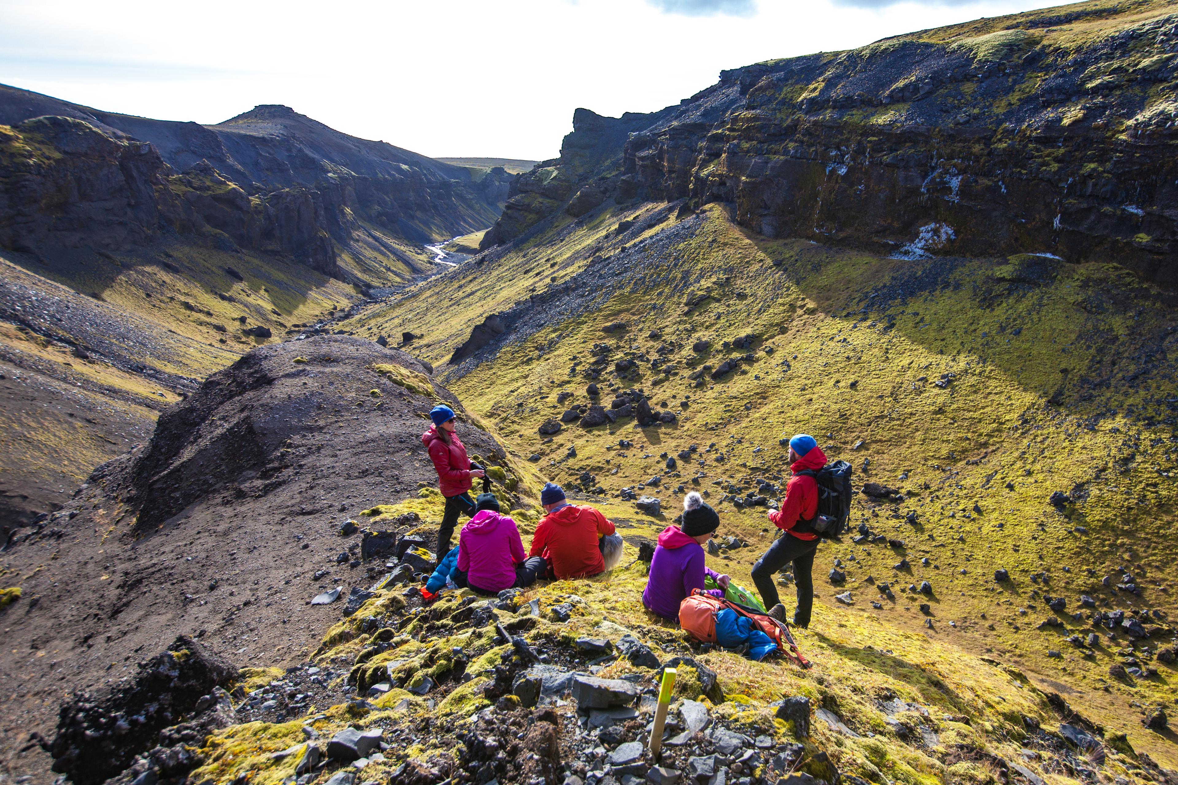 Group of hikers taking a break and having snacks