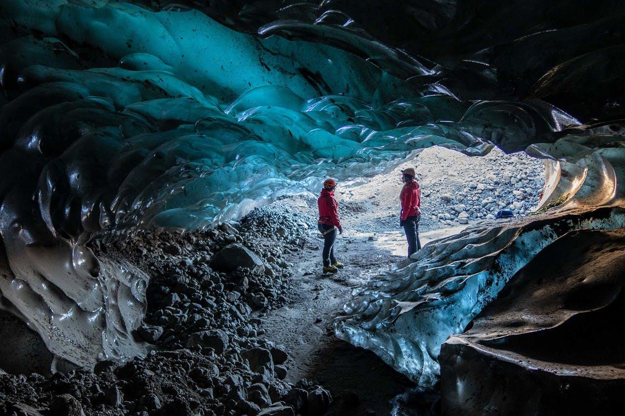 A couple inside of a ice cave