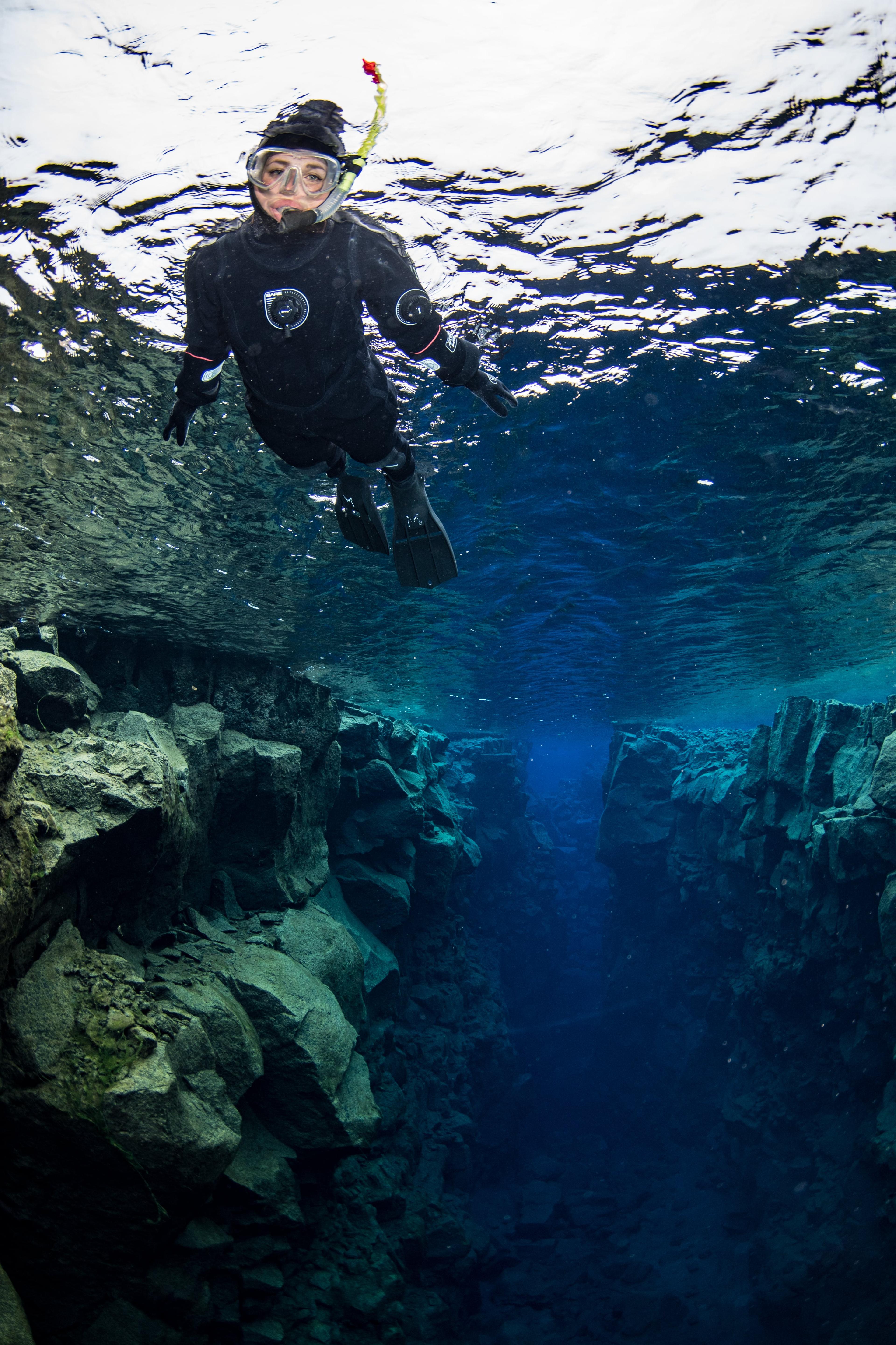 A woman snorkeling in Silfra fissure