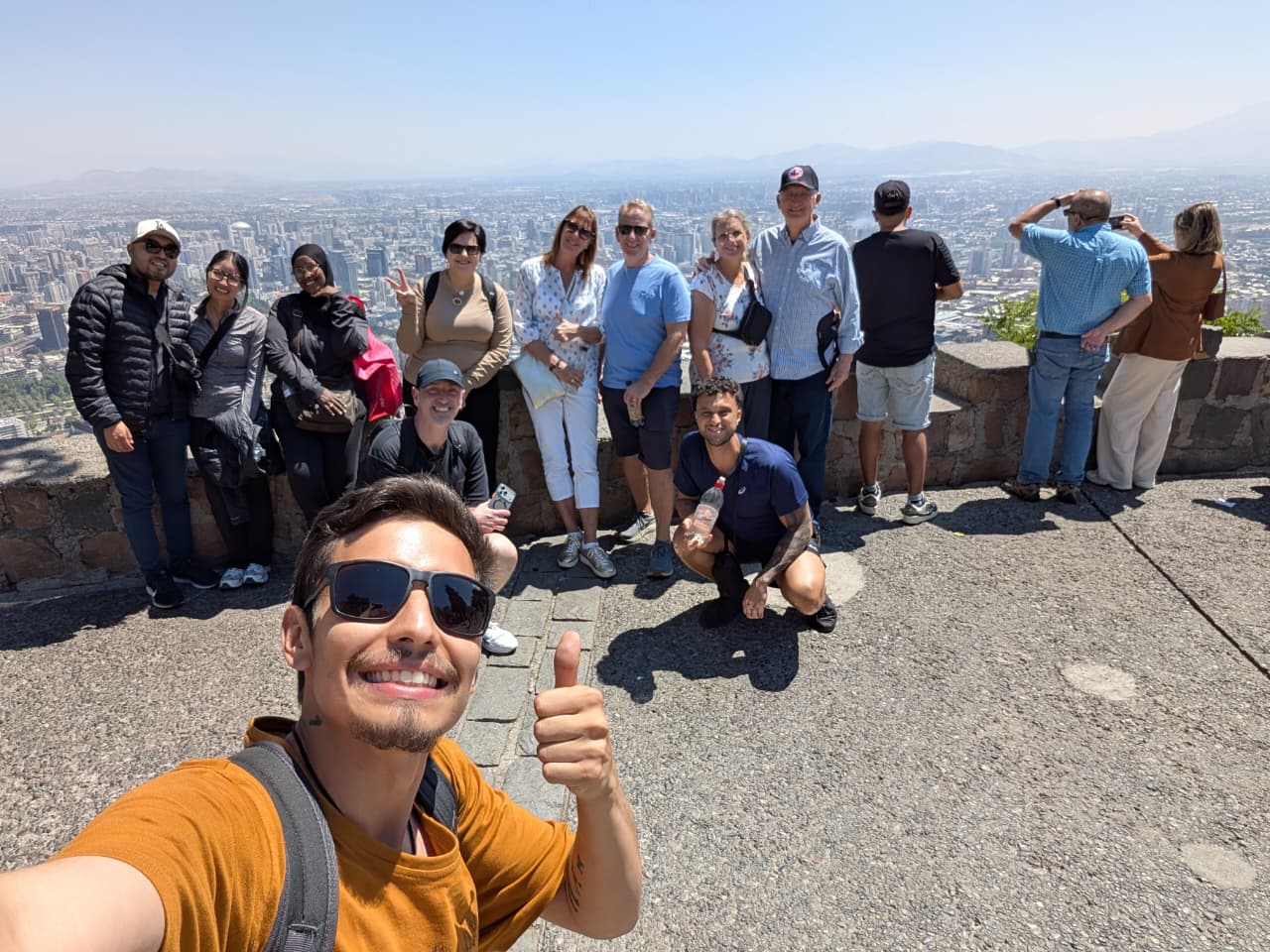 A group taking a selfie together at a city lookout point