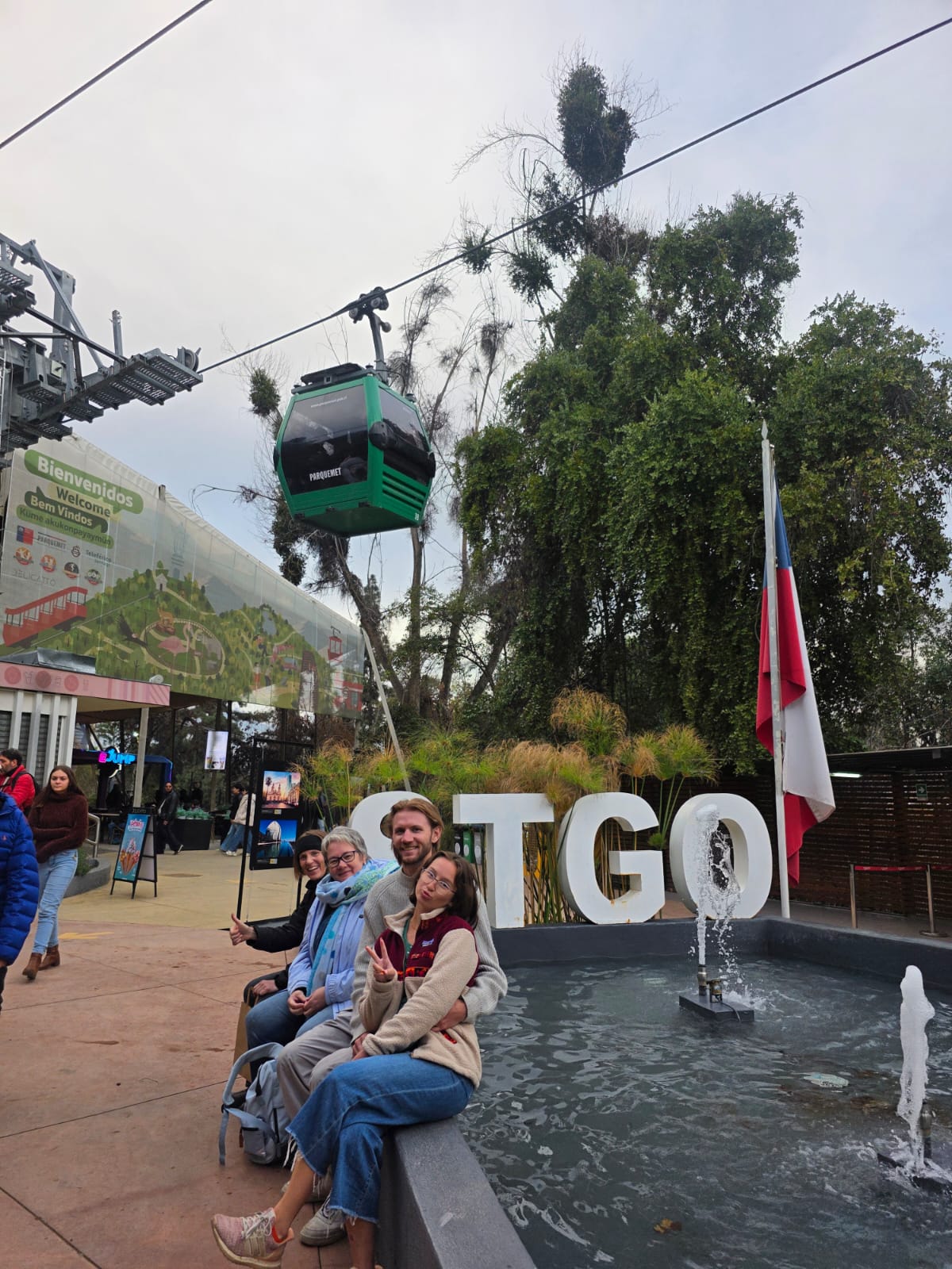 A Chilean flag flying near the giant "STGO" sign